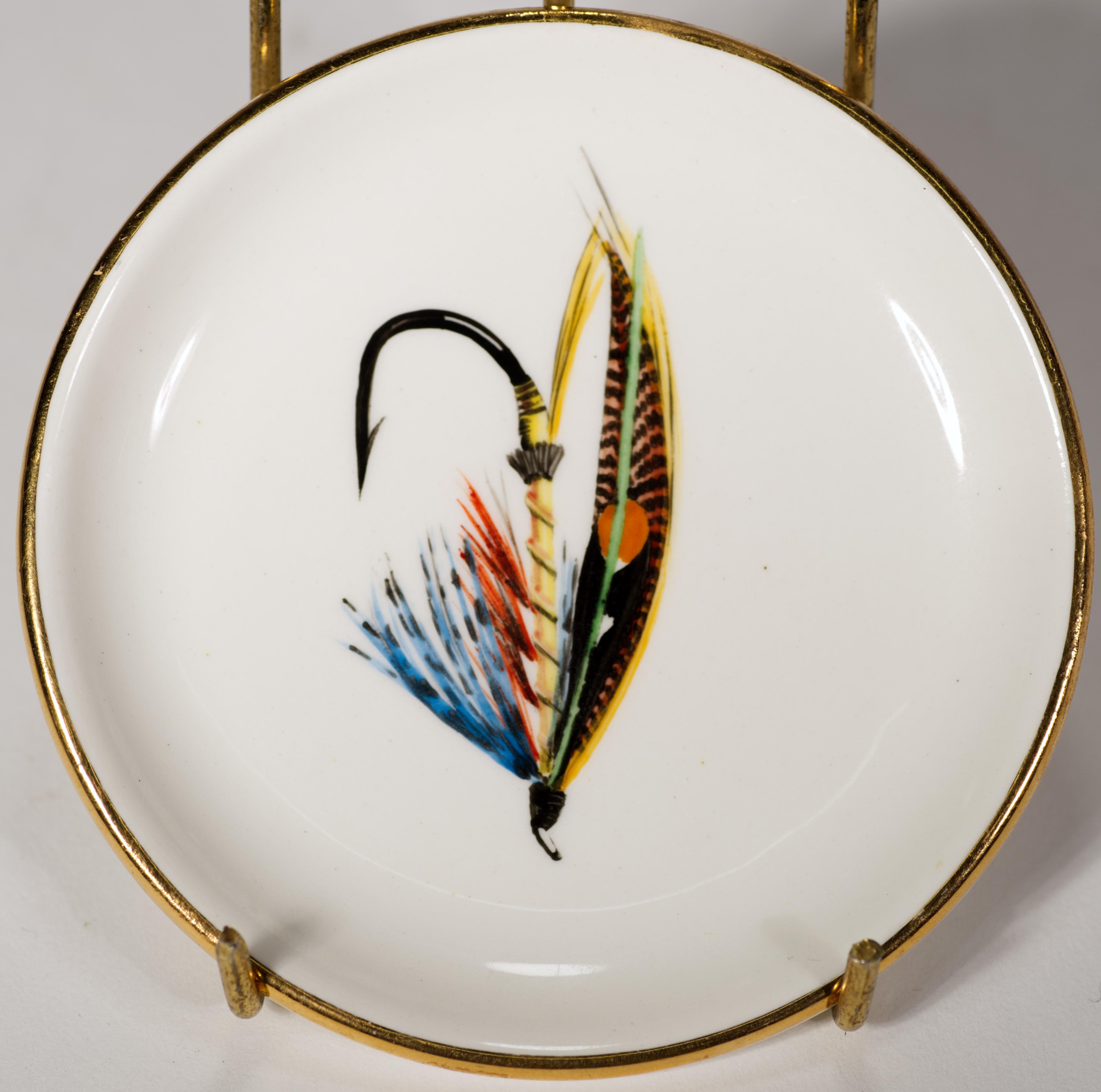 4 vintage ceramic coasters are illustrating different fishing fly: Dunkeld, Blue Doctor, Dusty Miller, and Silver Doctor. The coasters are hand painted and decorated with gold rims. Bright, distinct, and colorful designs make them a great functional