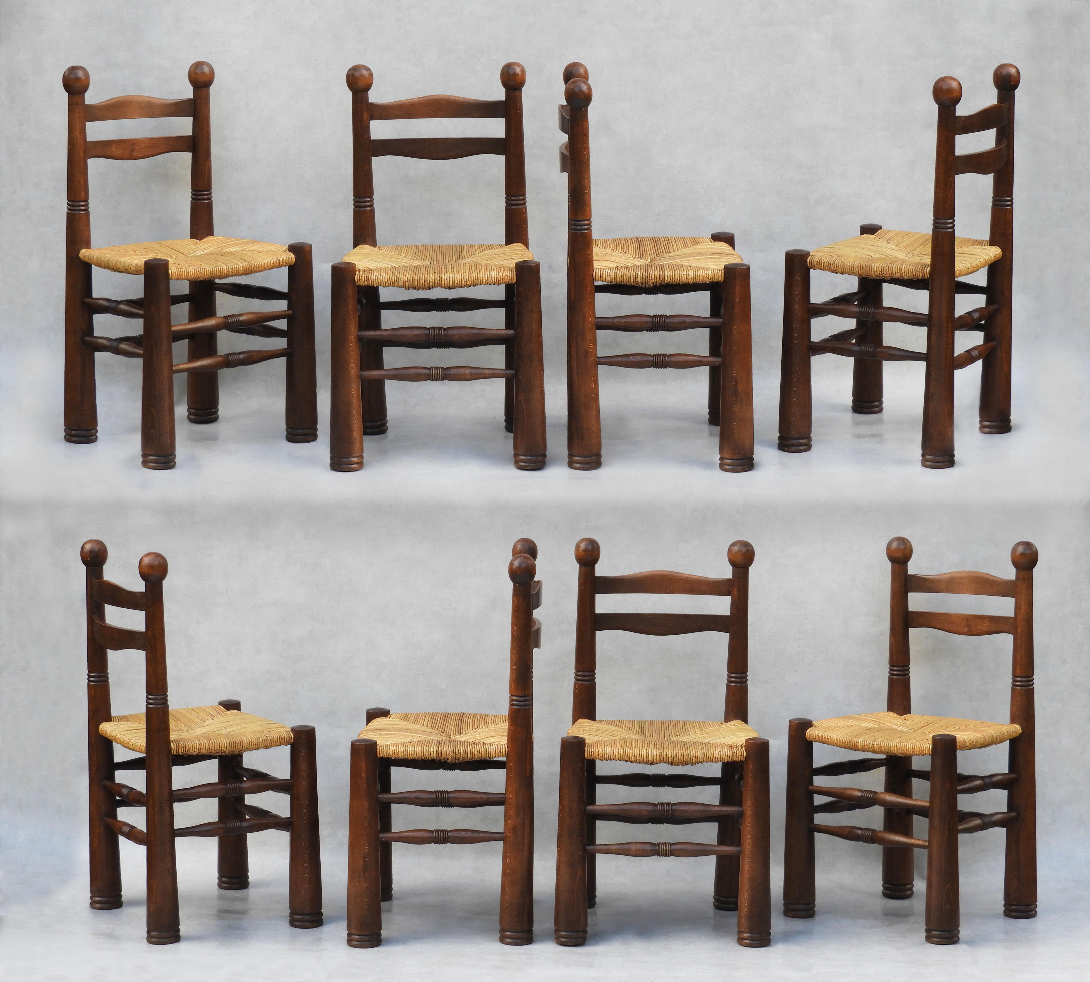 Fabulous and rare set of eight Charles Dudouyt, turned oak and woven rush seat, dining chairs, C1940s France.         Great design and good craftsmanship. All original medium oak frames, chunky tapered legs, wavy carved wood backs, signature ringed