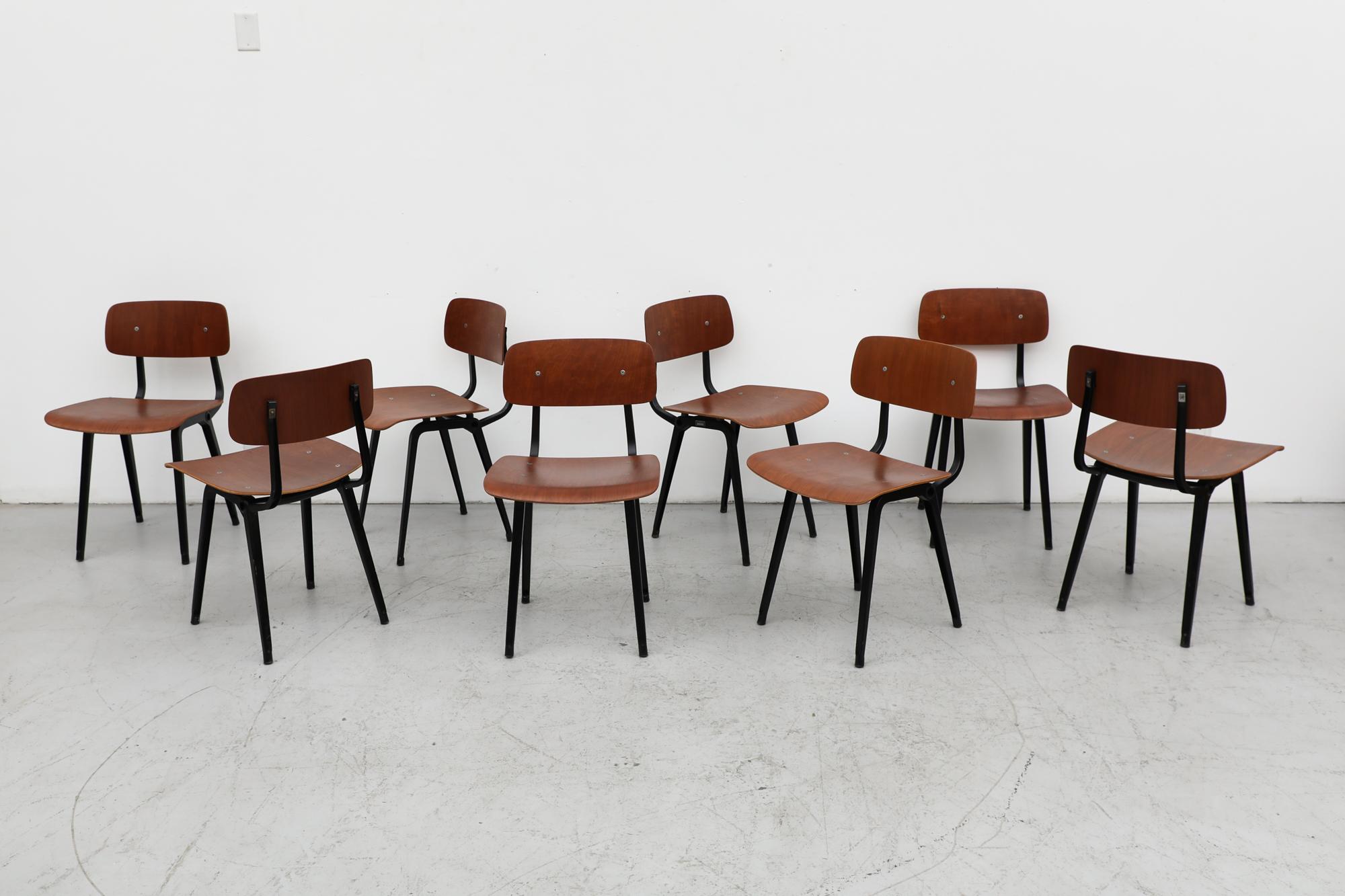 Rare set of 8 wood and metal Mid-Century Friso Kramer 'Revolt' chairs. This set has black enameled metal frames, teak stained plywood seats and back rests. The Revolt chair was designed in 1953 by Friso Kramer for Ahrend de Cirkel with a sleek style