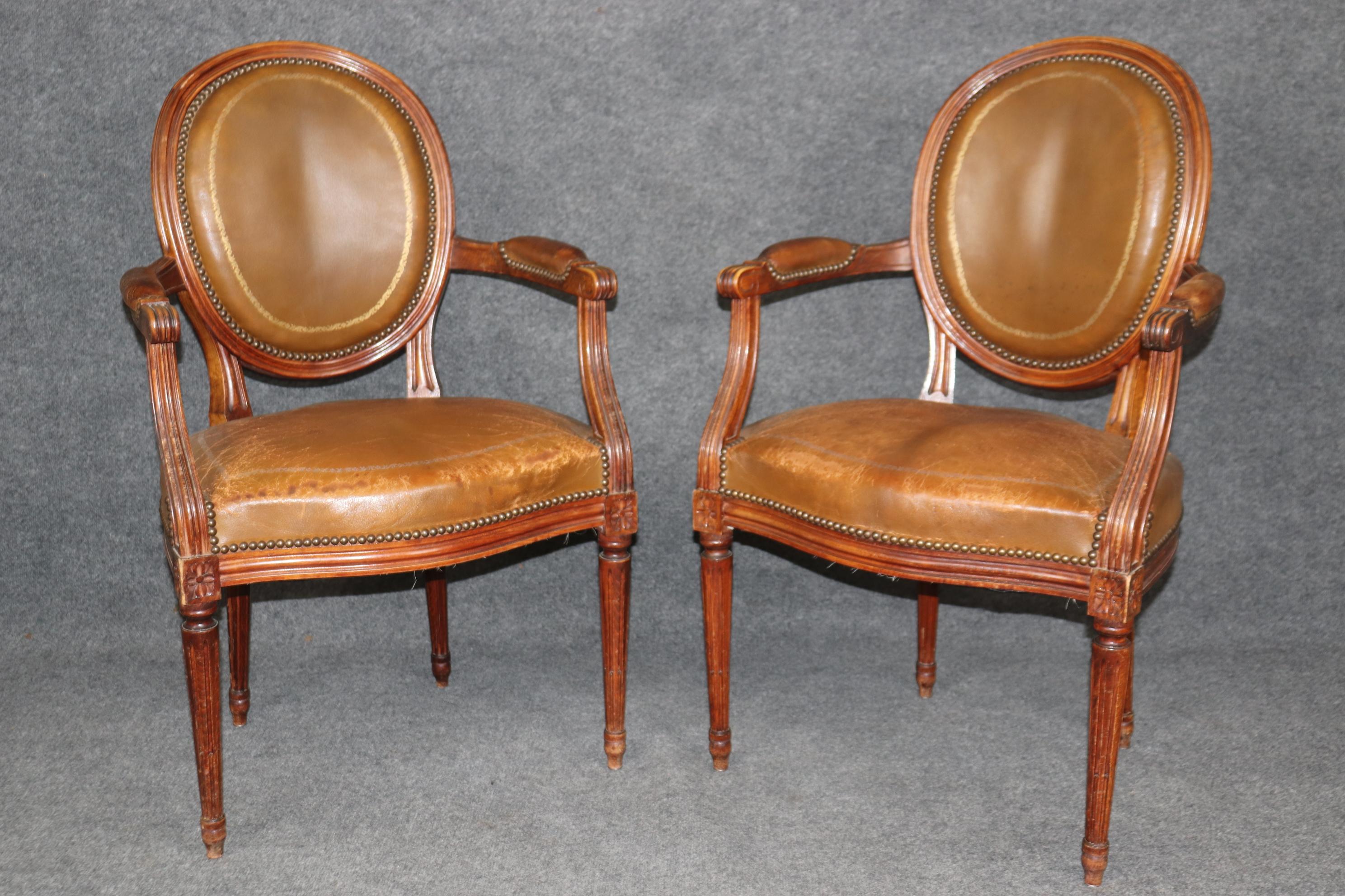   This is a gorgeous set of 8 chairs that have fine time-worn appeal and character. The chairs feature beautifully carved frames and gorgeous gold leaf embossed leather seats and will show stains and signs of use, but this can be repaired by a