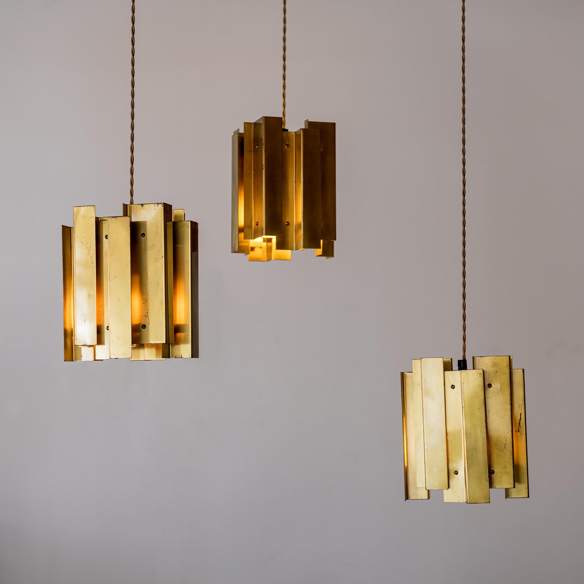 Stunning set of brass pendants by Carl Axel Acking, made-to-order for The Continental Hotel in Stockholm, Sweden, 1940s.

Listed dimensions are for the light fixtures. Drop is adjustable as desired.