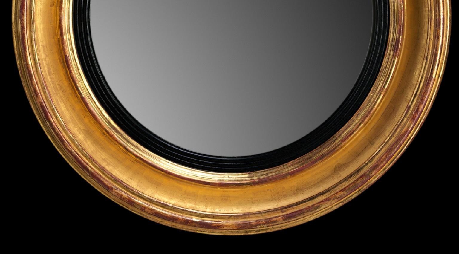 A Regency giltwood convex looking glass with a plain moulded frame.

We are currently working to a 30-36 week lead time.
                