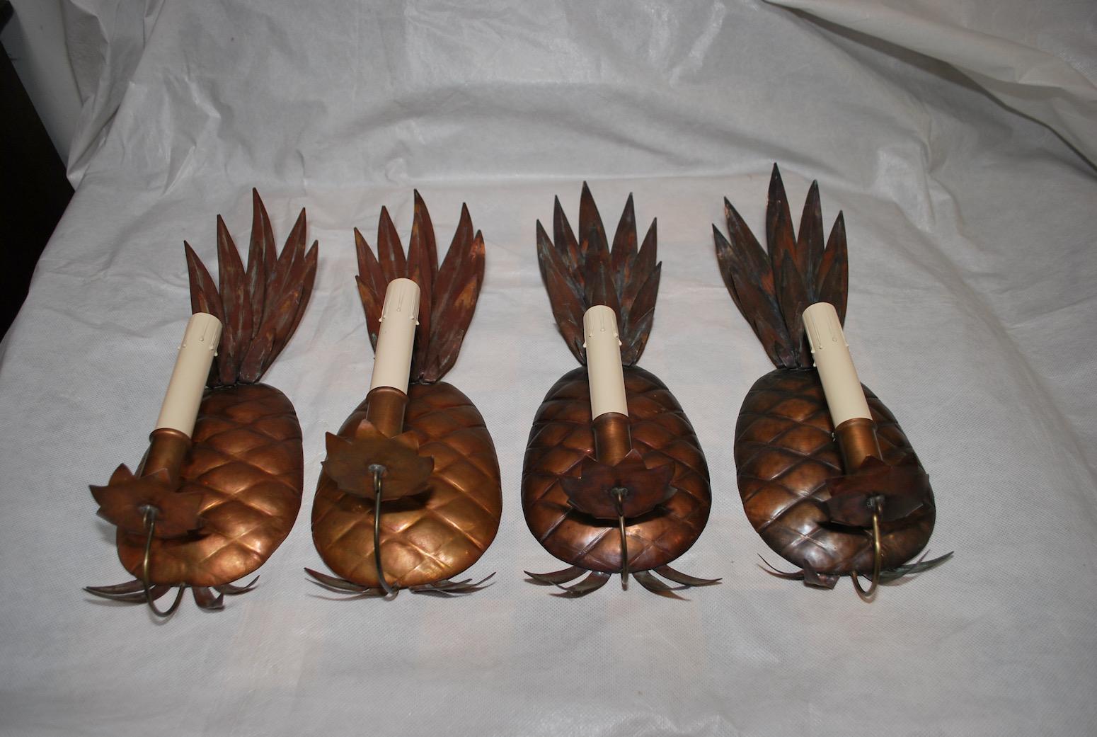 A cute set of four Pineapples sconces, perfect for a tropical ambiance, or a bar, made of copper, perfect for the beach, it won't rust, beware two are a little lighter then the other pair, originally they were candle, but was converted to