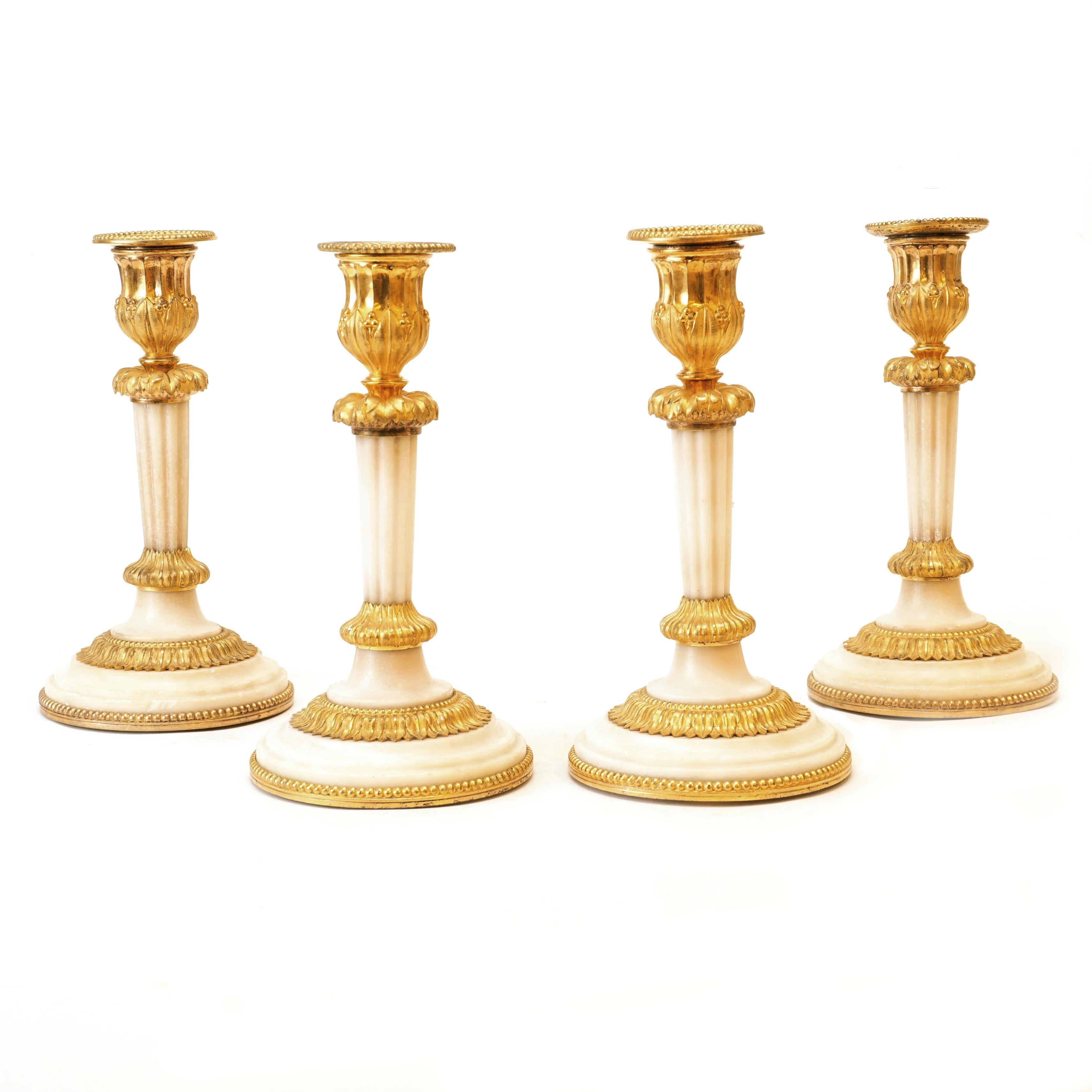 Rare set of four almost identical gilt bronze candlesticks with marble base,
France, circa 1810. Nice condition.