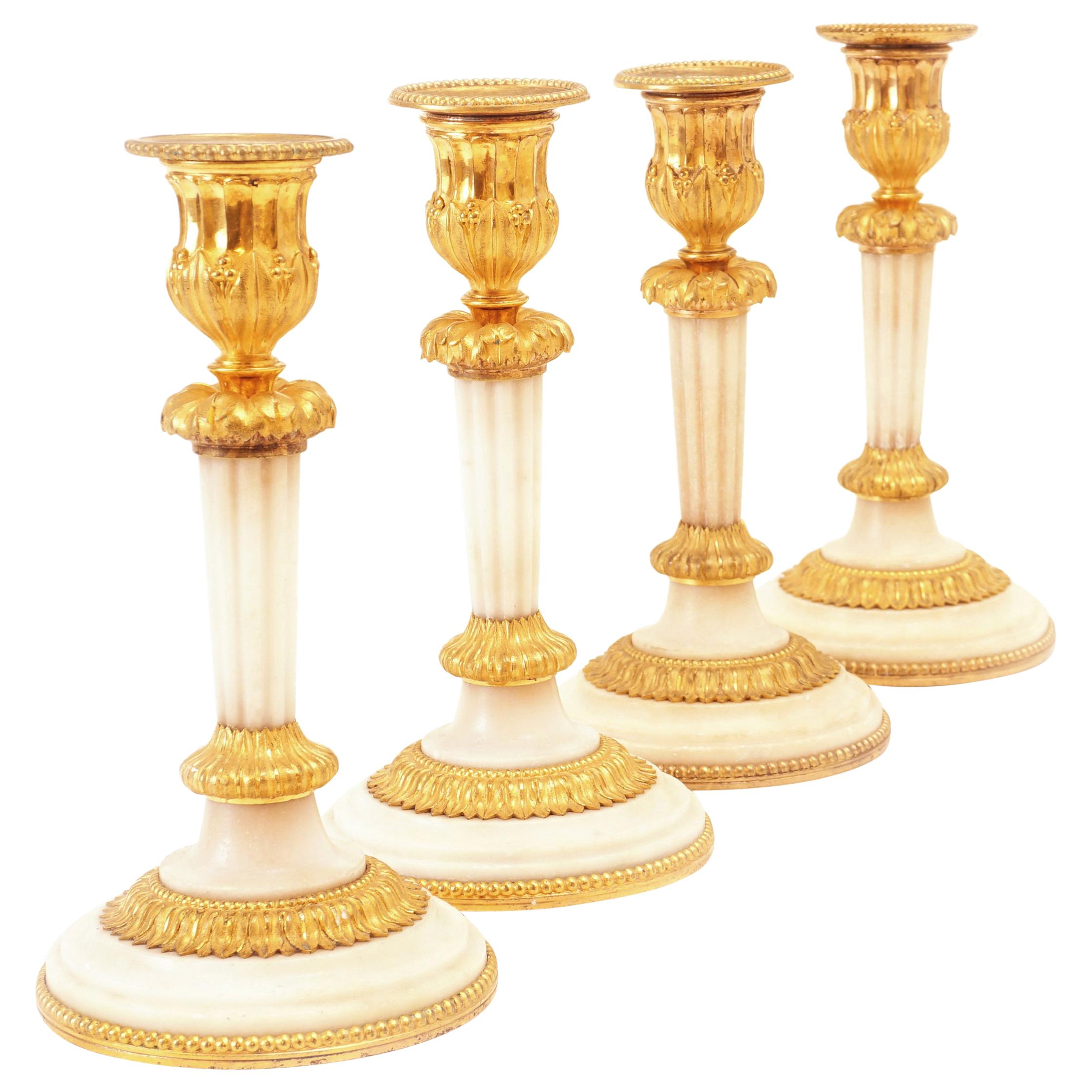 Rare Set of Four Almost Identicial Gilt Bronze Candlesticks with Marble Base For Sale