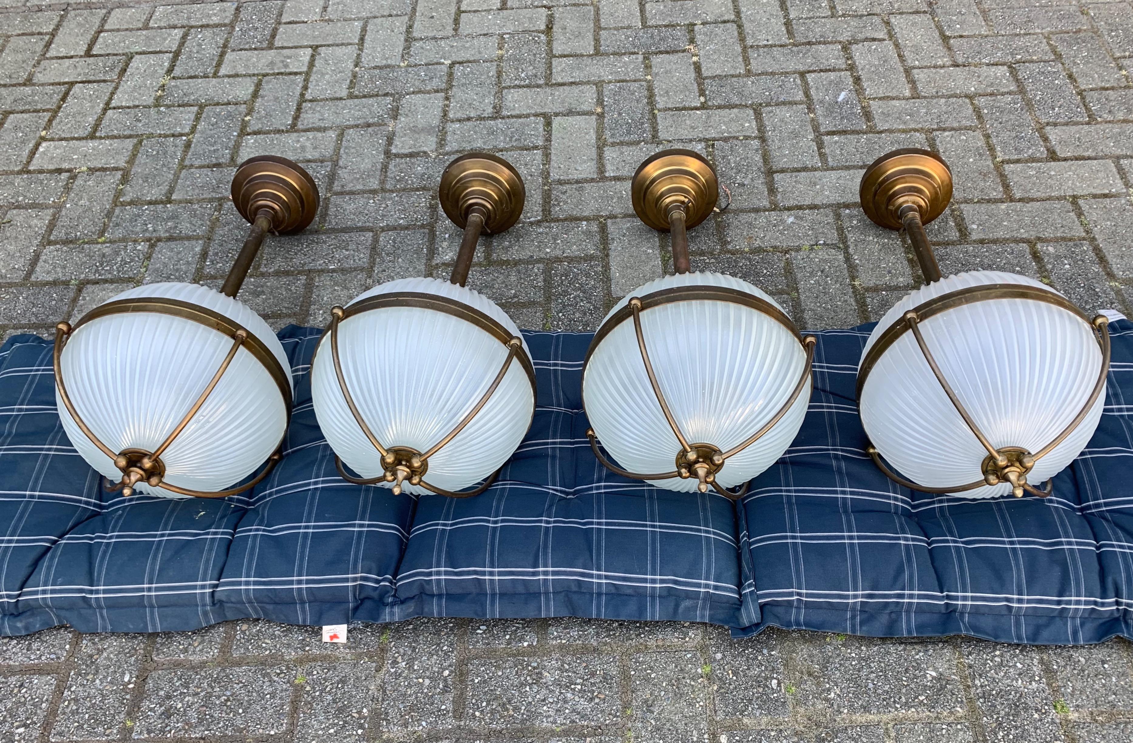 Good size and great shape group of four identical pendants.

If you are looking for a group of beautiful and truly stylish pendants for a midcentury or for an Art Deco interior then this set of four could be your perfect lighting solution. This