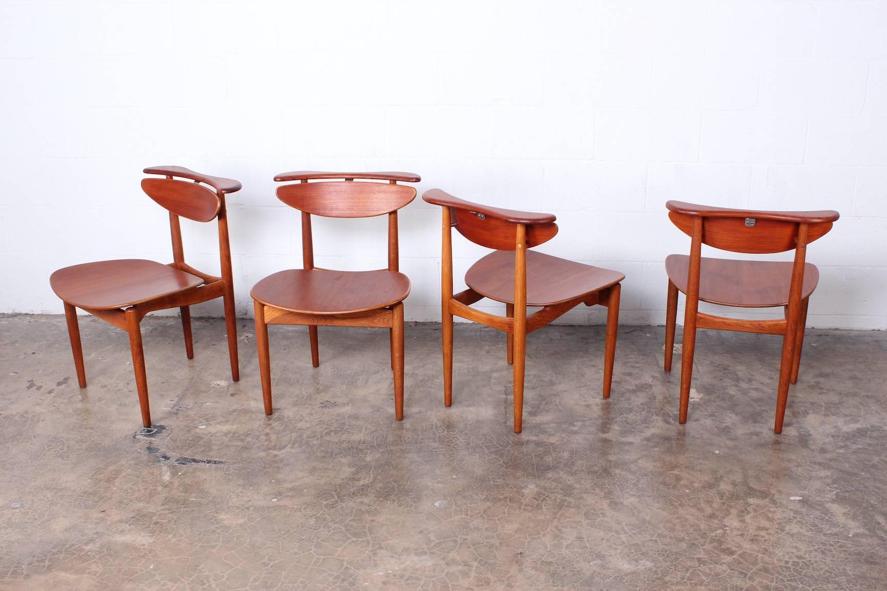 A rare set of four teak and oak dining chairs by Finn Juhl for Bovirke.