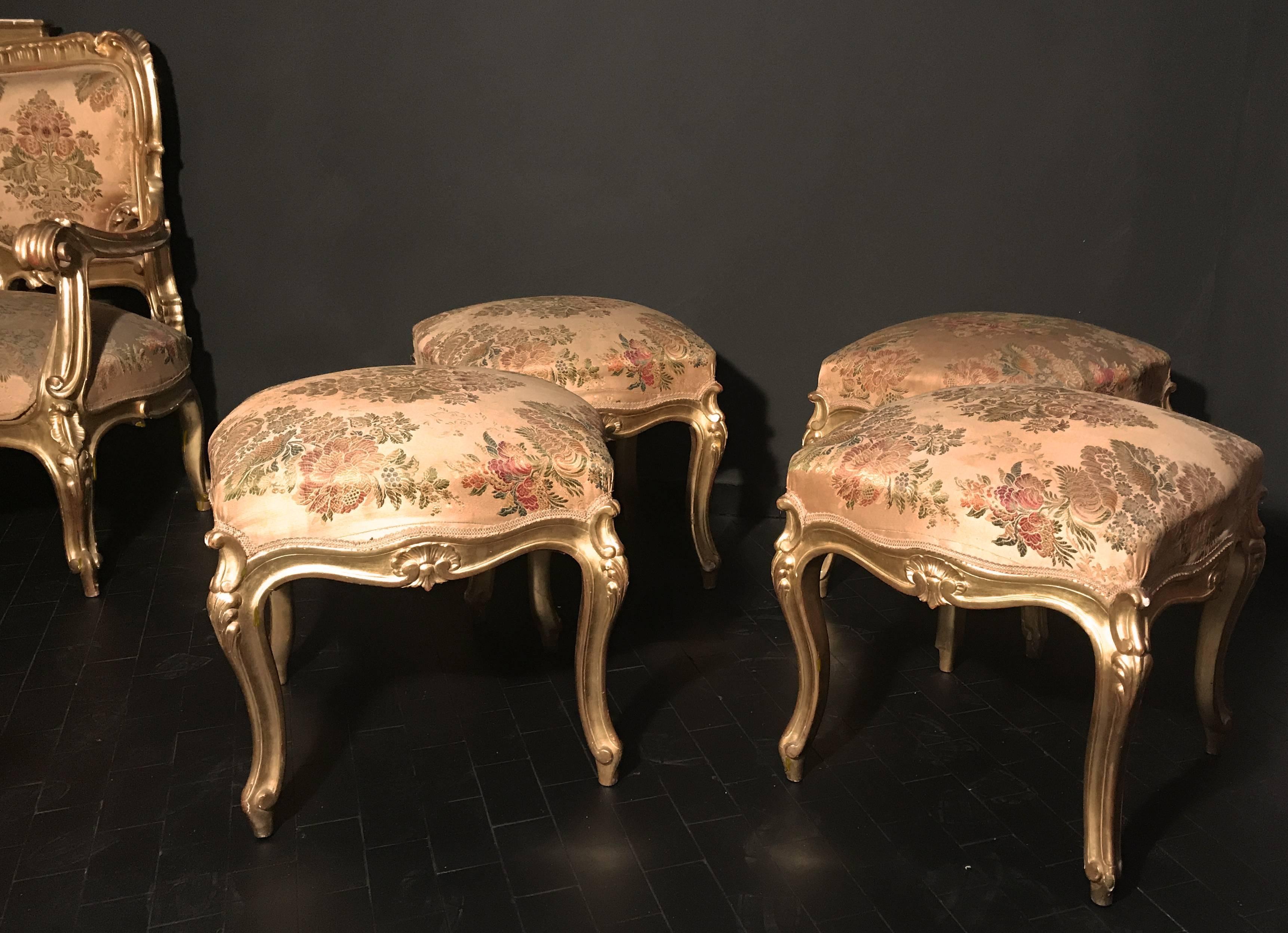 These finely carved and gilded square stools add a beautiful touch to your living spaces. They are carved on all four sides with elegant cabriole legs. Excellent condition of gilding.
This set is part of an eleven piece s salon set published