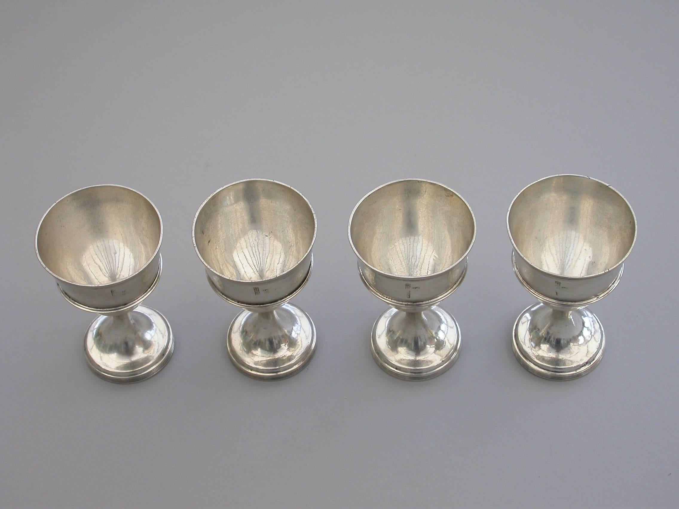 A rare set of four George III Irish Provincial silver egg cups, of plain form without-set reeded girdles and borders, raised on circular spreading pedestal bases with reeded rims.

By Carden Terry & Jane Williams, Cork, c1810

In good condition