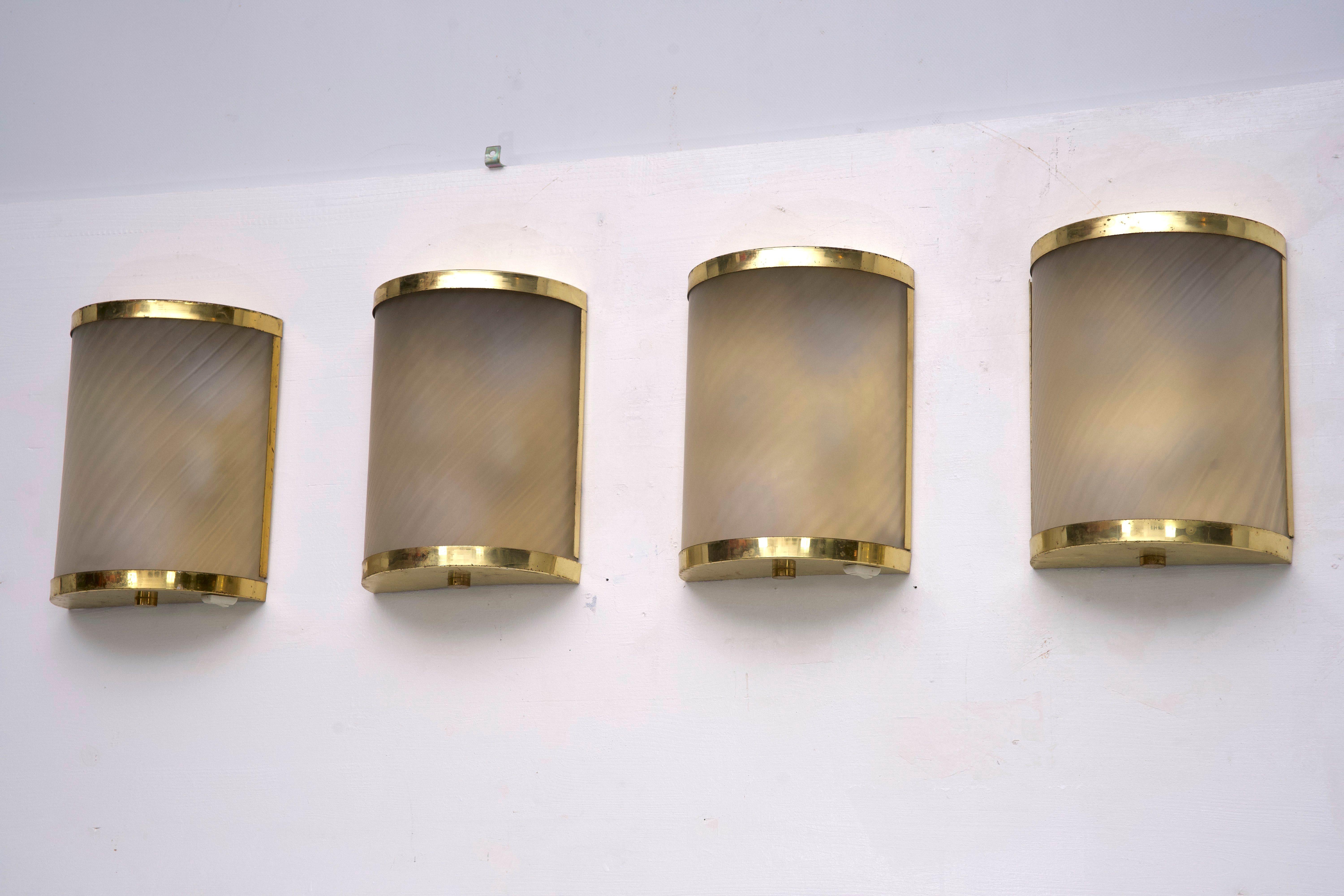 An exceptional and rare set of four wall sconces designed by Valentino, the renowned Italian fashion house, in the 1980s. Crafted from high-quality brass and featuring beautifully etched glass shades, these sconces embody luxury and elegance. Each