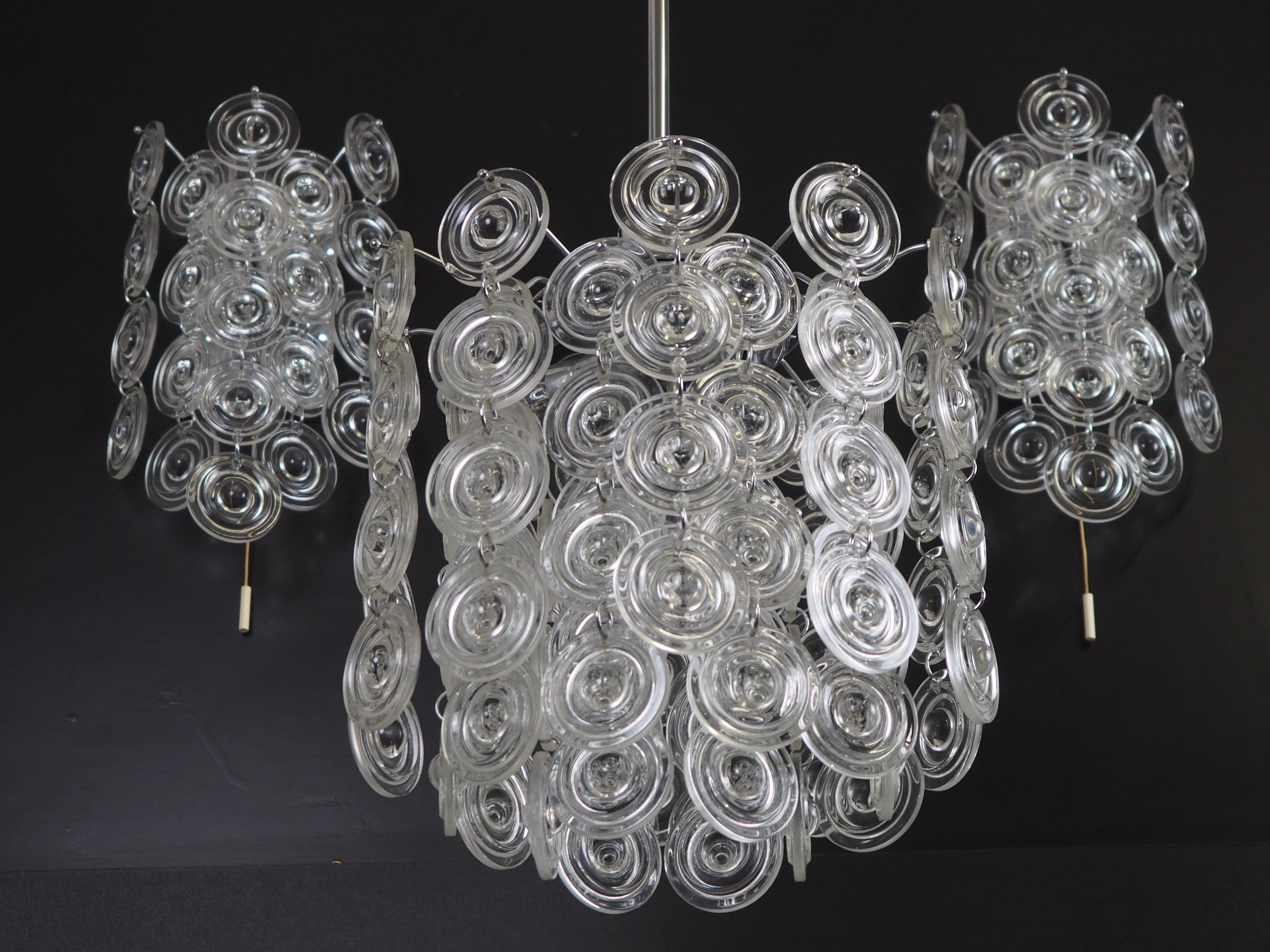 Very rare mid-century set of three glass and nickel light fixtures by Sciolar, Italy, circa 1970s.
This high quality pieces are made of many clear Murano glass disk hanging on the nickeled brass frame.

The totaly height of chandelier is 27.1