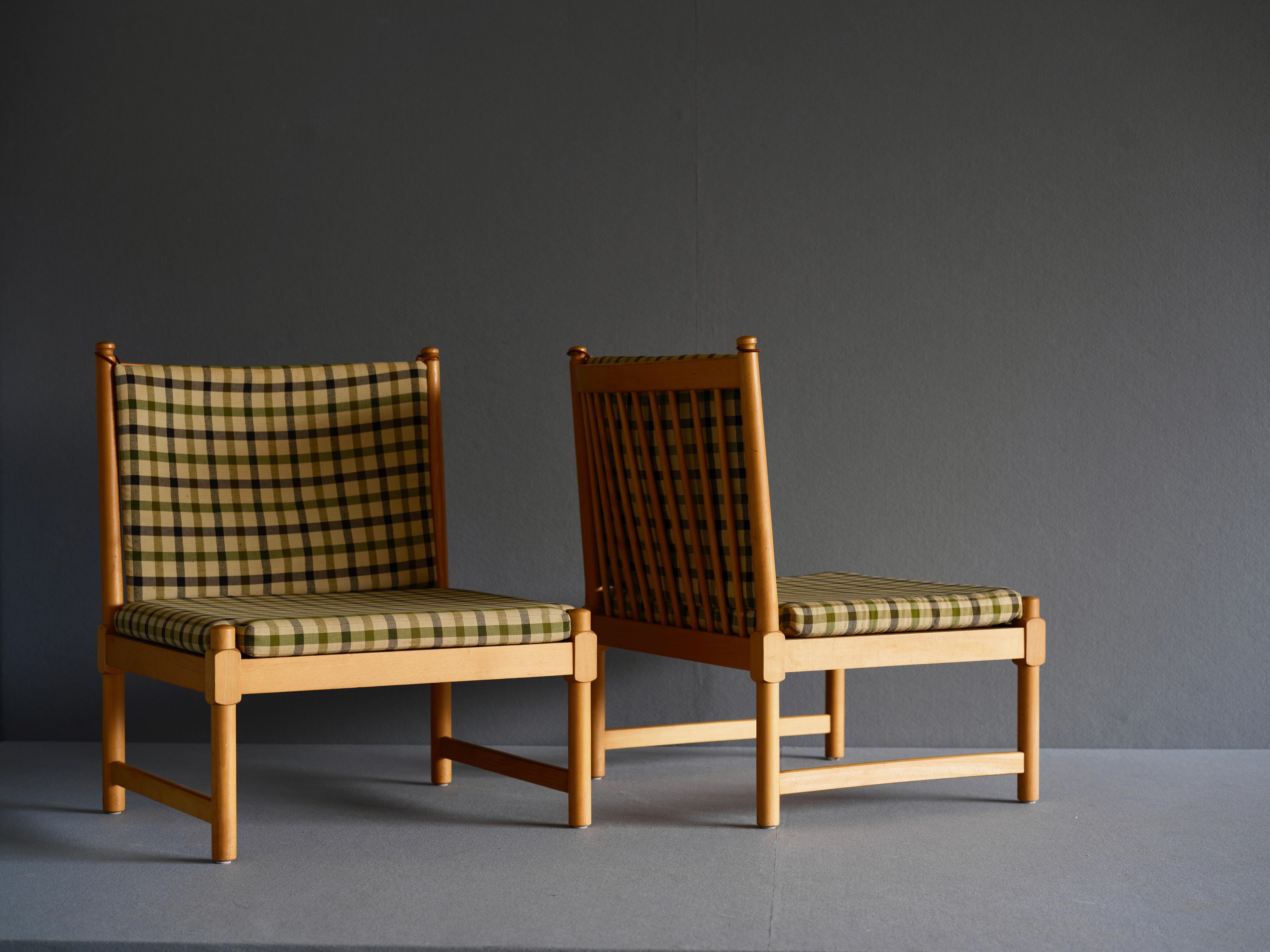 A matching pair of lounge chairs with matching ottoman by Borge Mogensen for Frtiz Hansen. This set in in beech and is upholstered in wool. The original label remains. Circa 1966.

This set was part of the private collection from the estate of