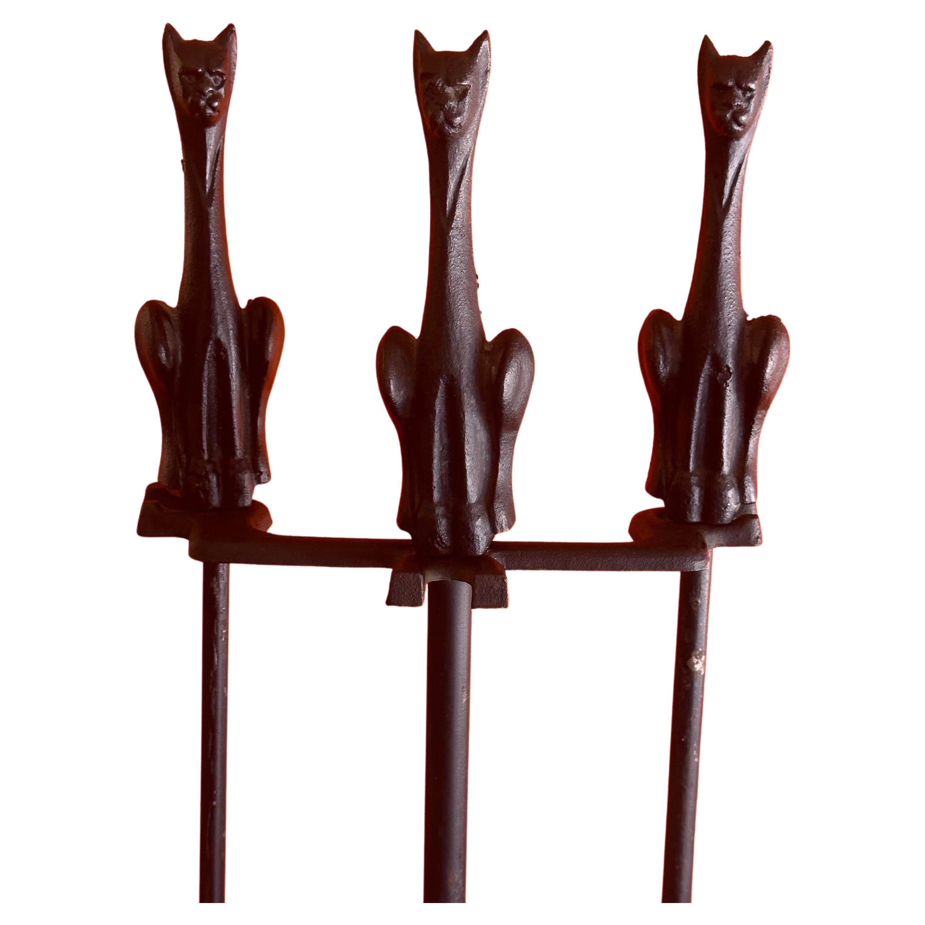 An extremely rare set of MCM fireplace tools with cat handles and stand, circa 1950s. There are three tools (shovel, brush and poker) and a single stand in good vintage condition. The set is heavy and well cast with a great look; it measures 11