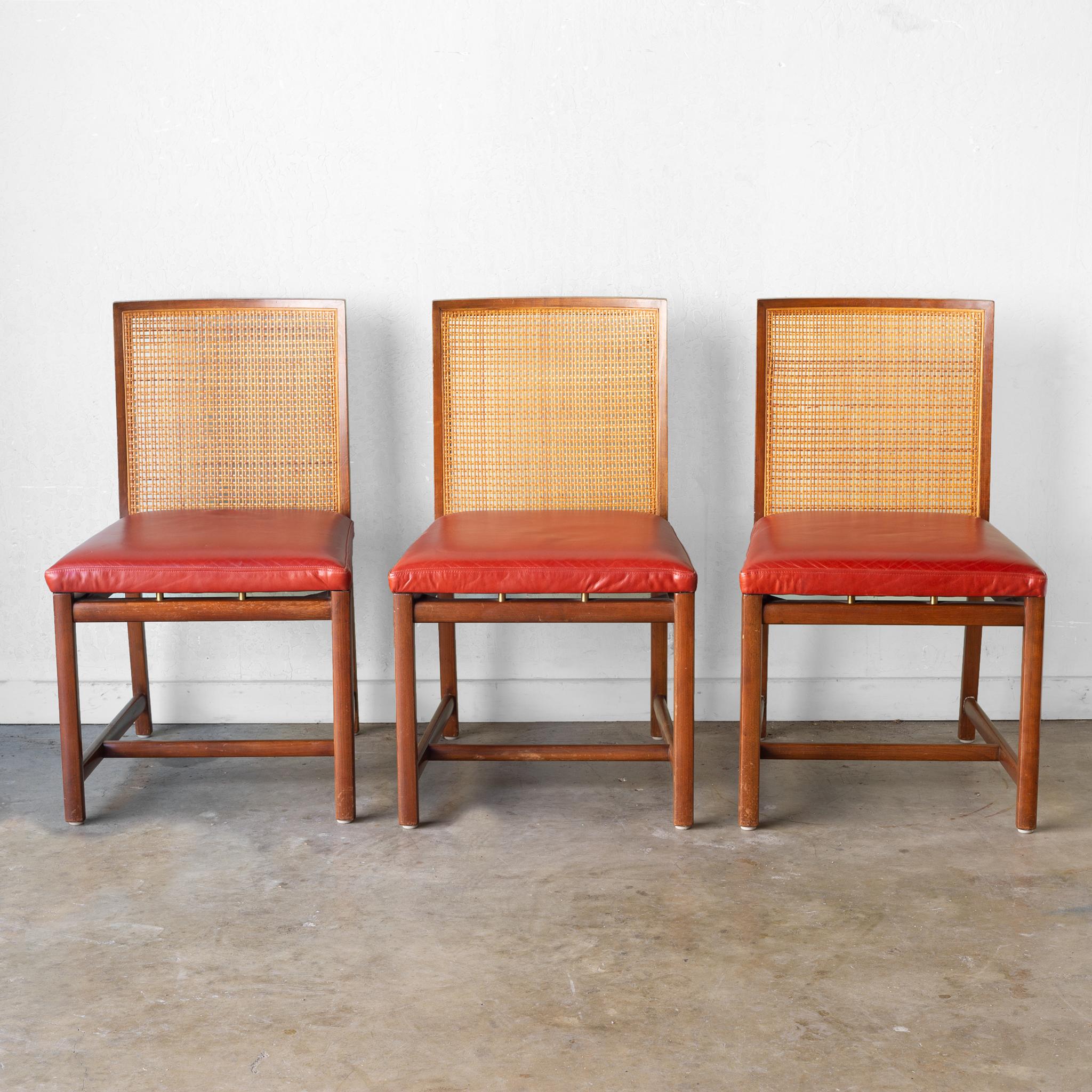 Low production series of dining chairs from the boutique New World collection by Michael Taylor for Baker, circa 1960.
Solid cherry frame with cane back detail finished in a walnut stain. Michael Taylor's signature “floating” leather seats above