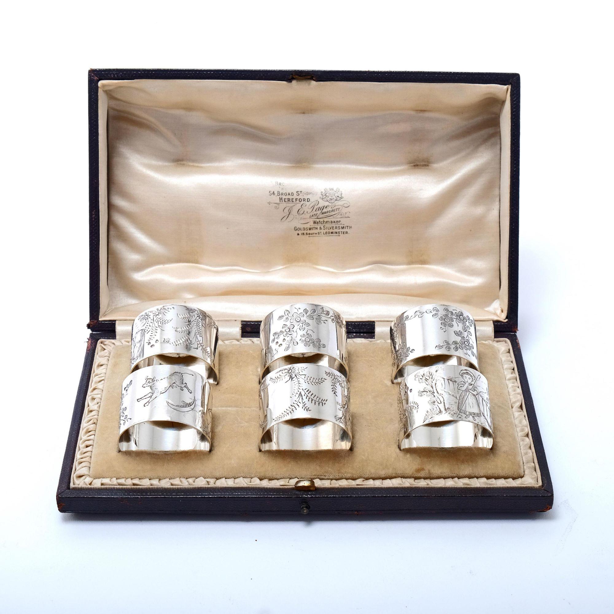 Wonderful and rare set of six Victorian silver napkin rings each one individually hand-engraved with a scene from a different nursery rhyme and fitted in their original presentation box. The back of each has an empty cartouche surrounded by either