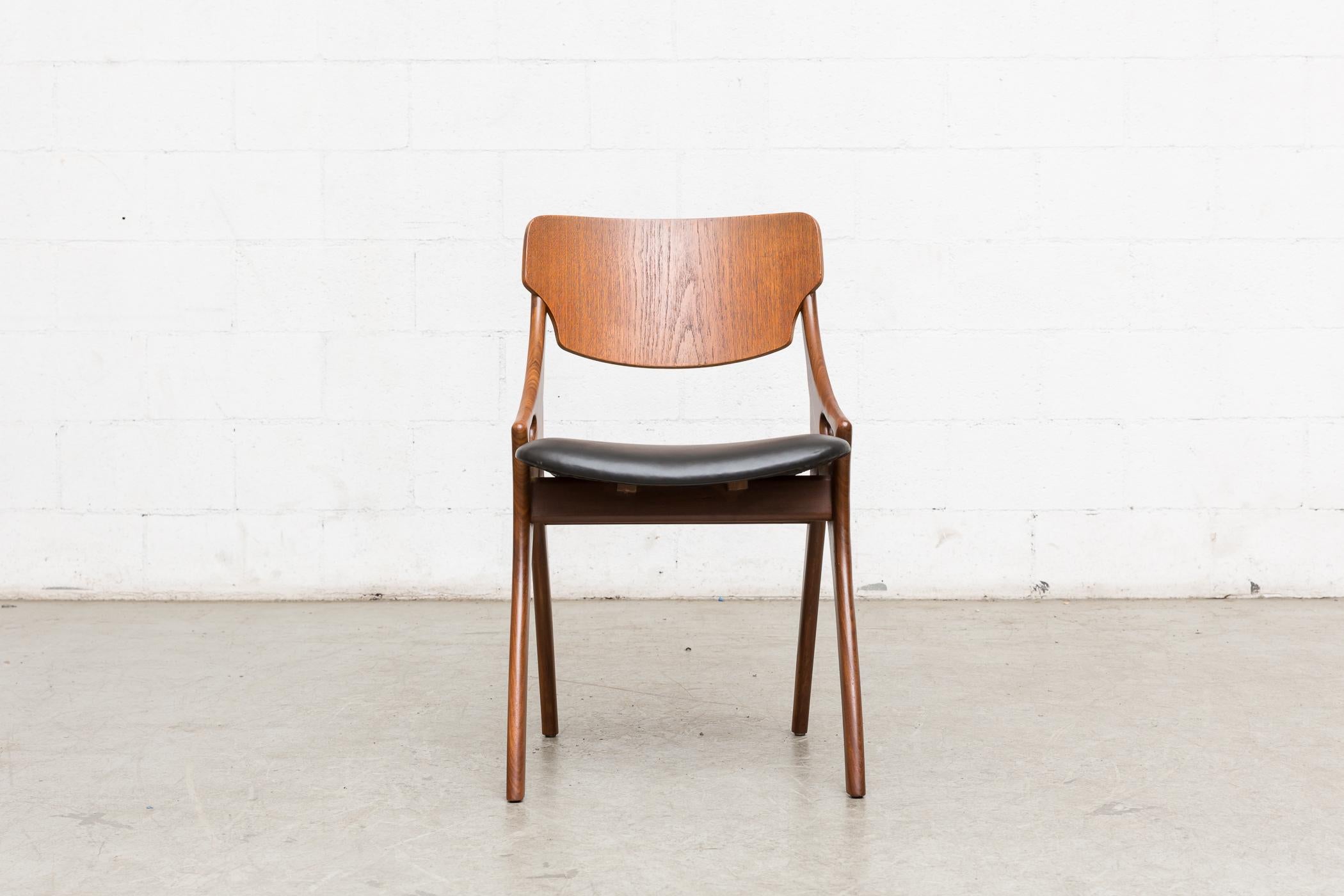 Set of six teak dining chairs by Arne Hovmand Olsen for Mogens Kold. Manufactured in the 1950s, Denmark. Each chair features organically sculpted teak arms with teak backrests and original black skai seating with visible wear. All the chairs are in