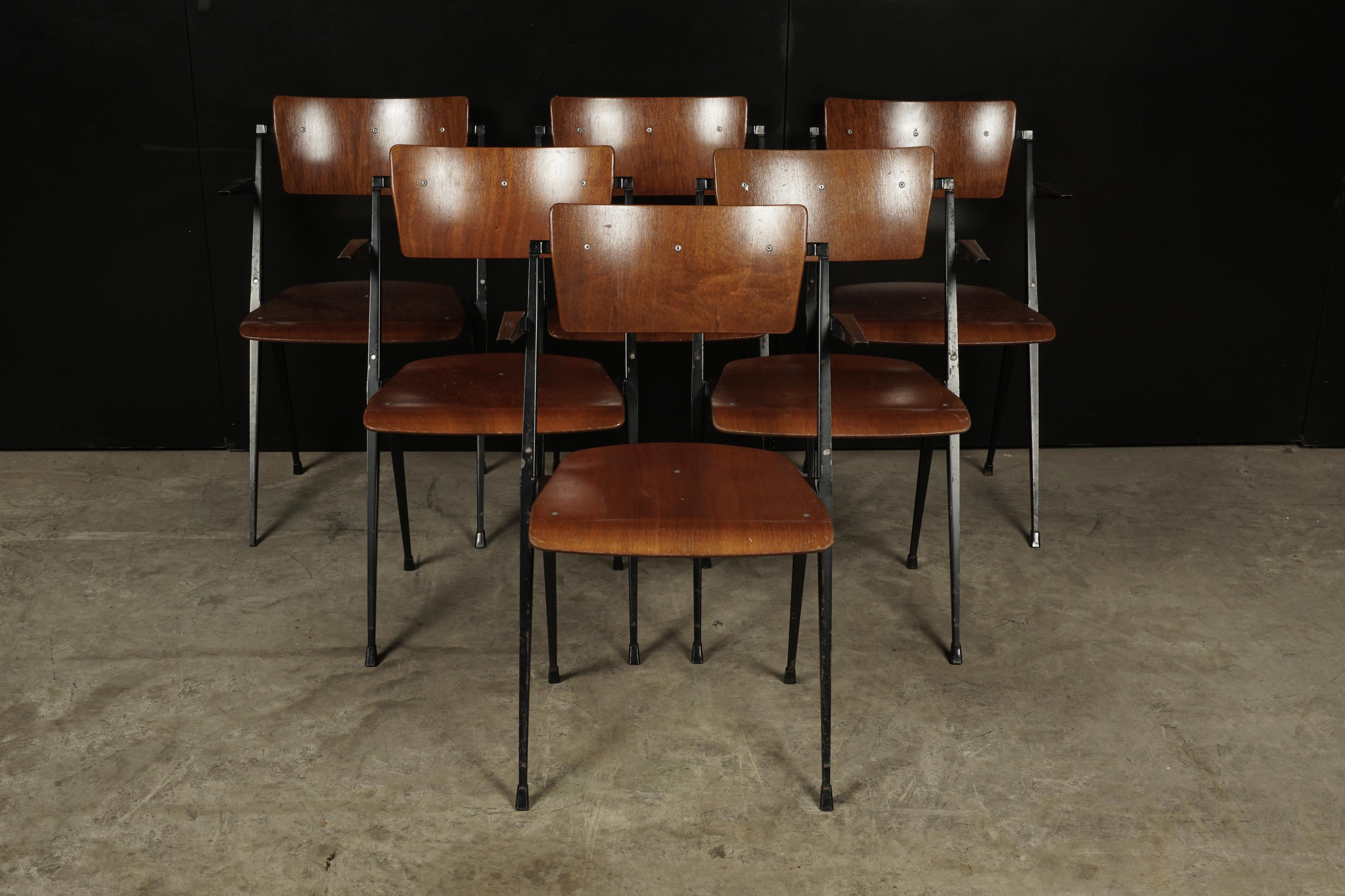 Rare set of six stacking chairs designed by Wm. Rietveld, circa 1960. This rare chair won a famous ‘Signe d’Or’ design award in 1960. Very original condition with visible Scapes to the metal and enamel. Minimal chipping on some of the wood surface