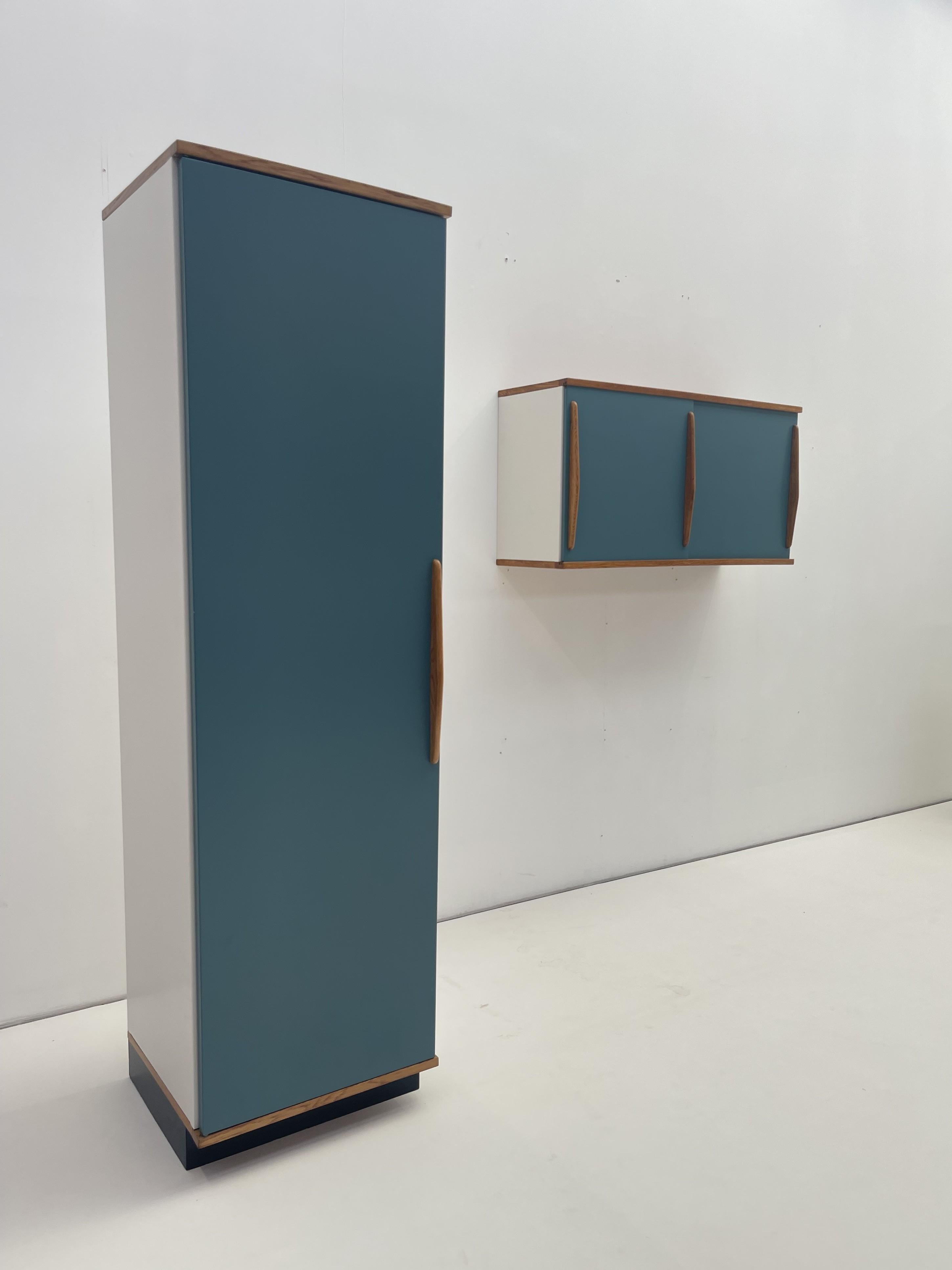 This vintage kitchen storage set, designed by renowned Belgian designer Willy Van Der Meeren, epitomizes the sleek, functional aesthetics of mid-century modern design. Crafted in metal, this set features a tall standing cabinet and a wall-mounted