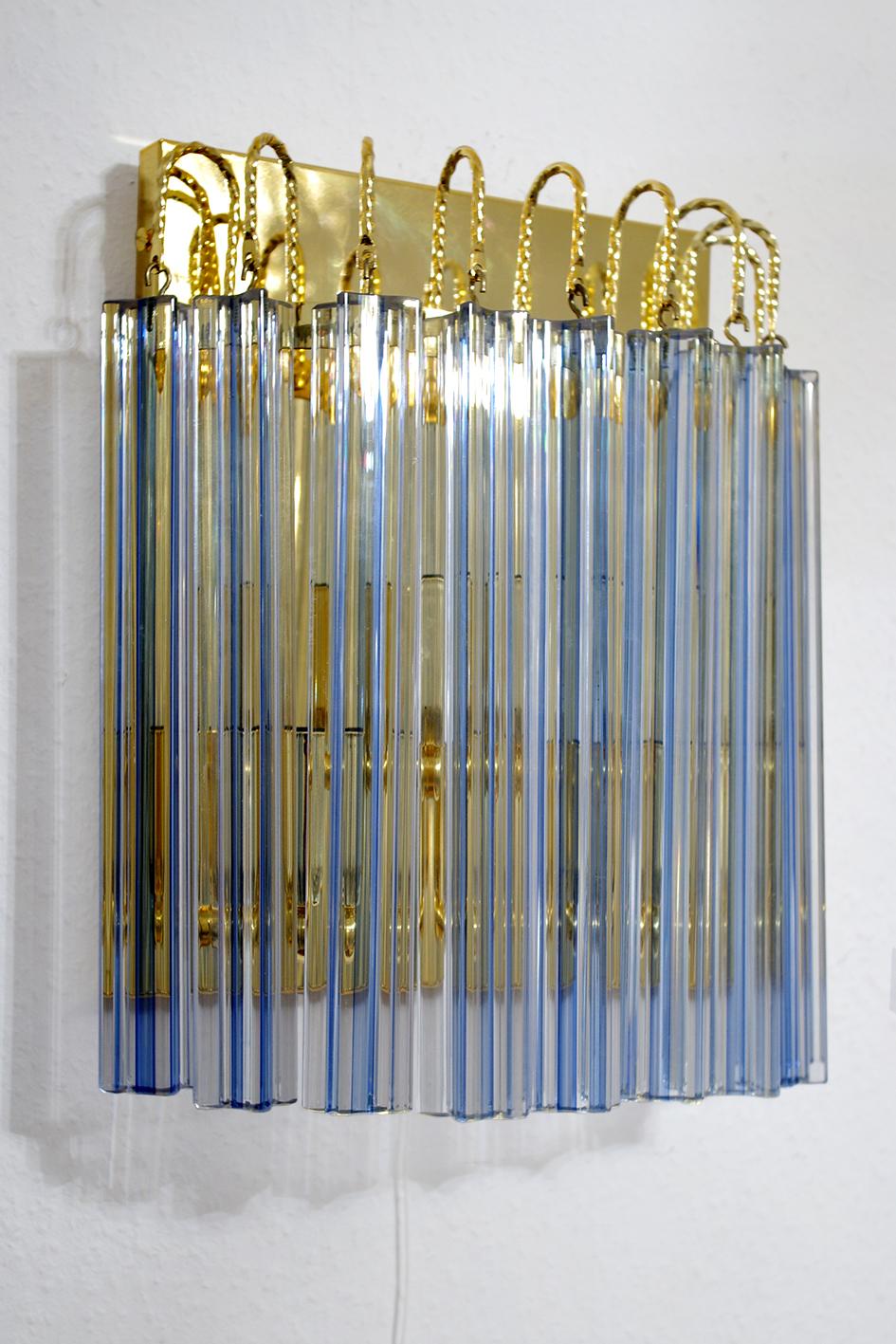 Set of three beautiful crystal prisms and gold plated brass wall chandeliers/sconces.
Austria, 1980s.

    