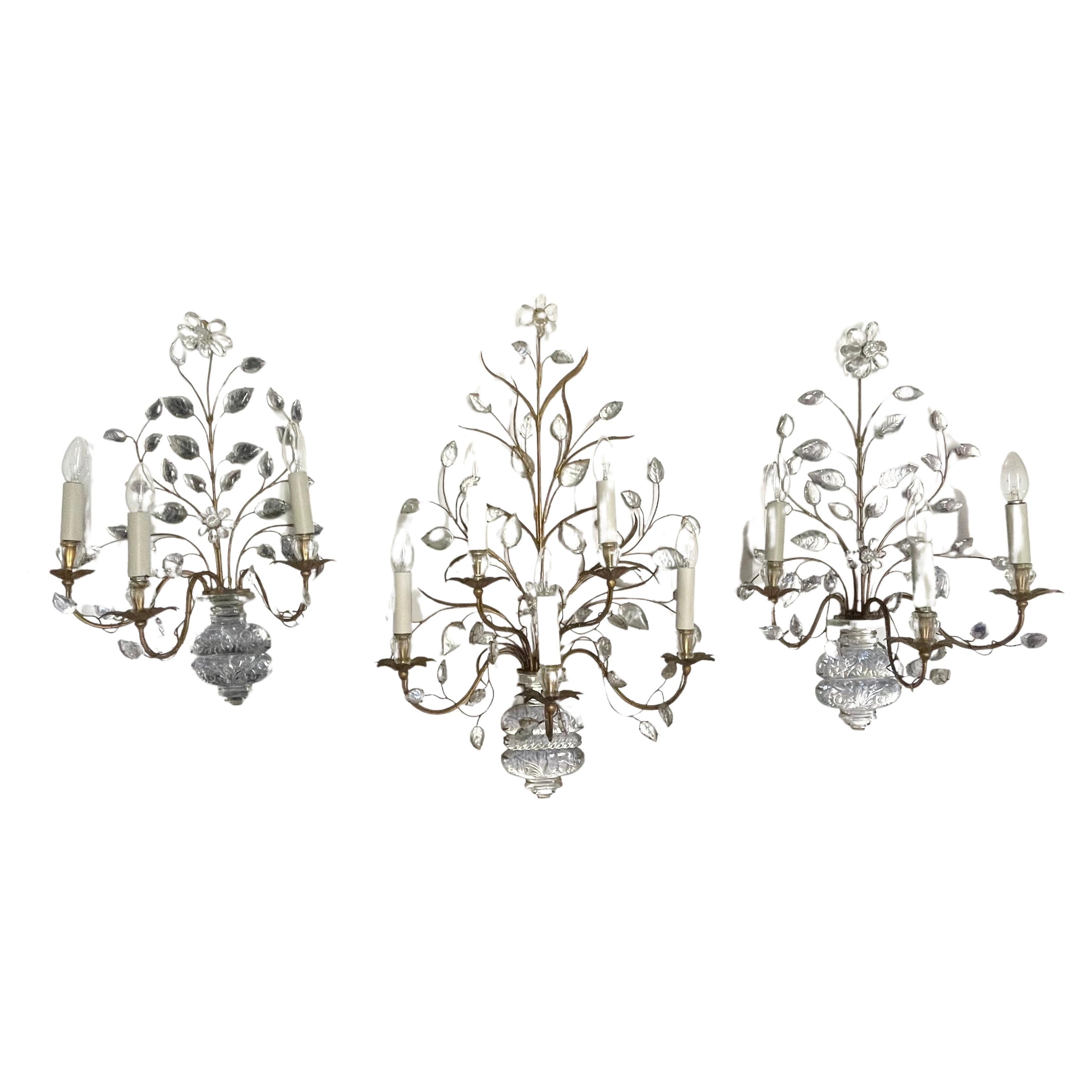 A wonderful and rare set of three large gilt iron and crystal wall sconces by Maison Baguès, Paris, circa 1930s.
The measurements o a three-lights sconces:
Height 24.40 inches x Width 16.53 inches x D 9.44 inches

The dimensions of the with