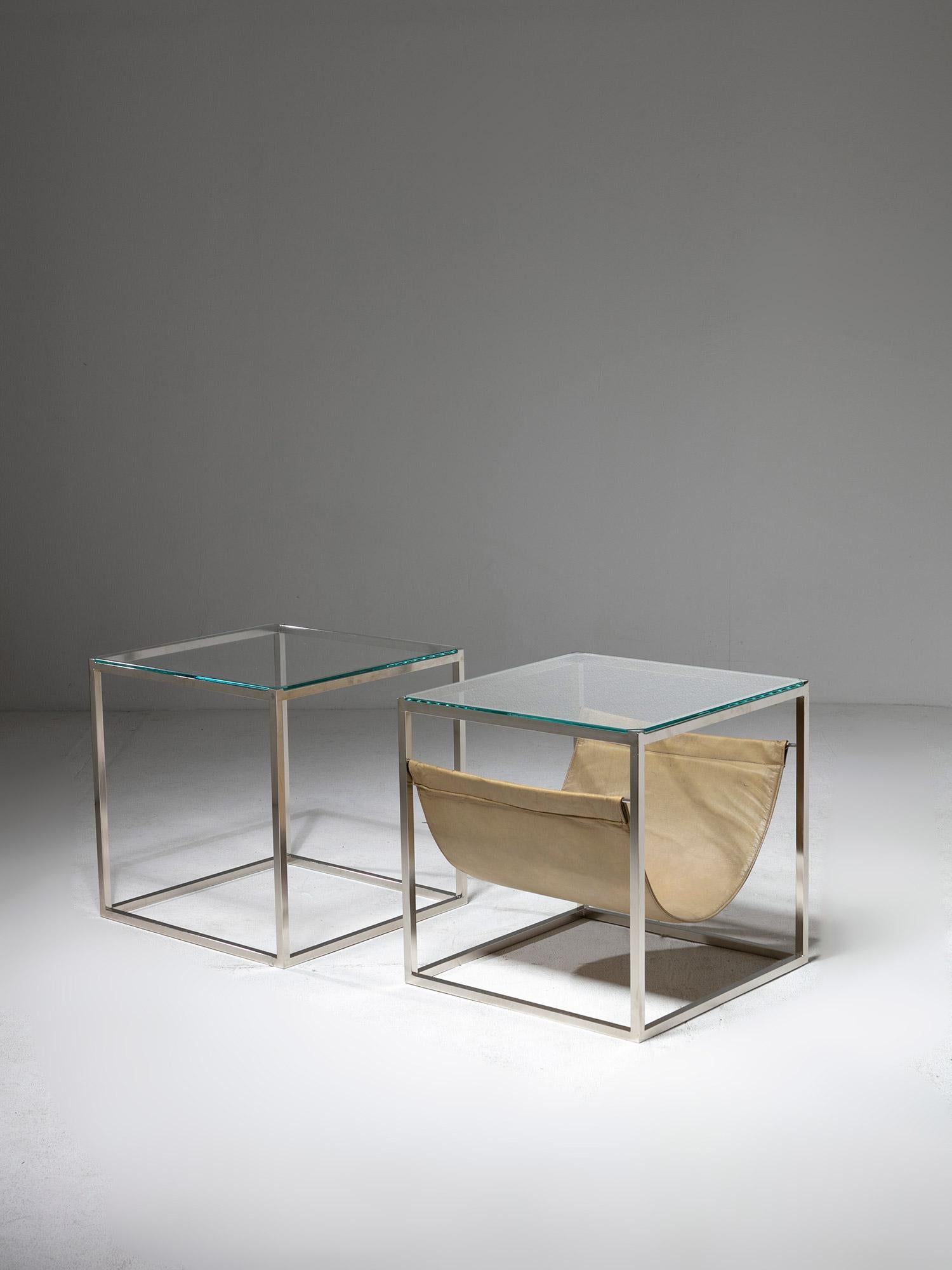 Set of two side tables by Lino Sabattini for Sabattini Argenteria.
Squared metal frame and glass top with cut edges. 
One piece features a capable leather pocket.
