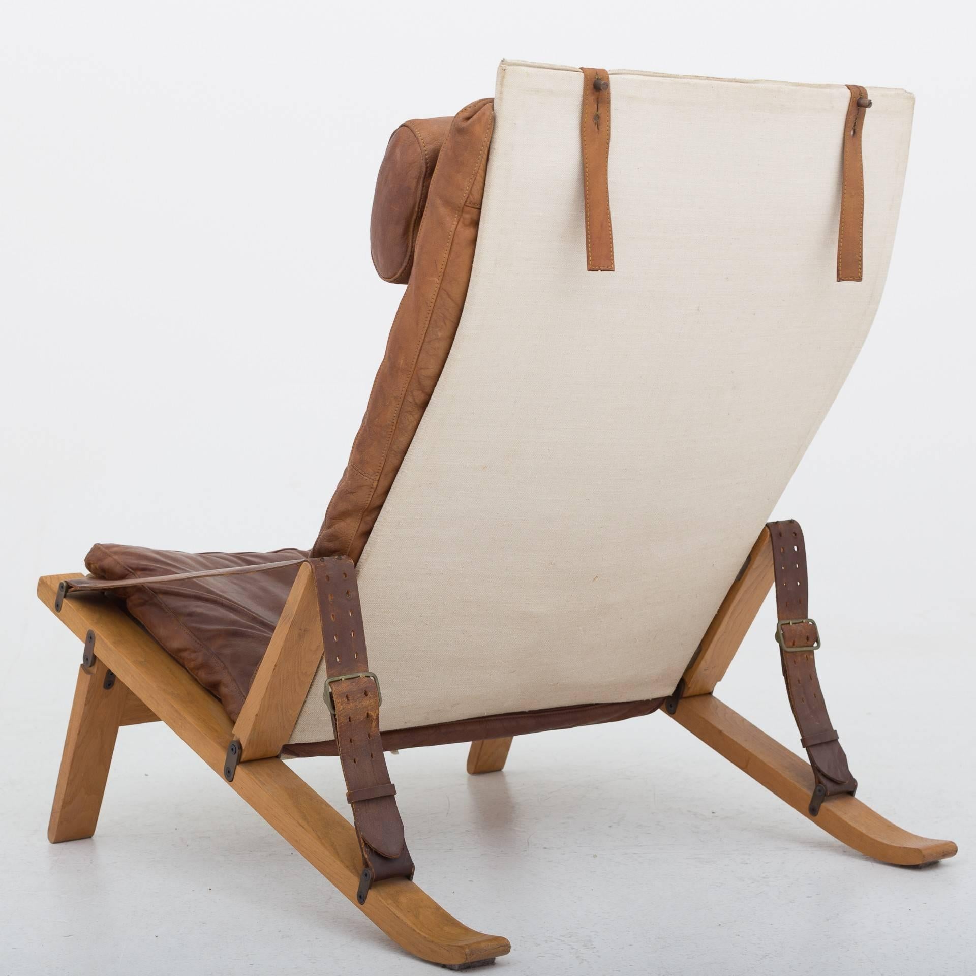 Two lounge chairs in oak, patinated brown leather and canvas. Designed by Preben Fabricius and Jørgen Kastholm. Maker cabinetmaker Poul Bachmann.