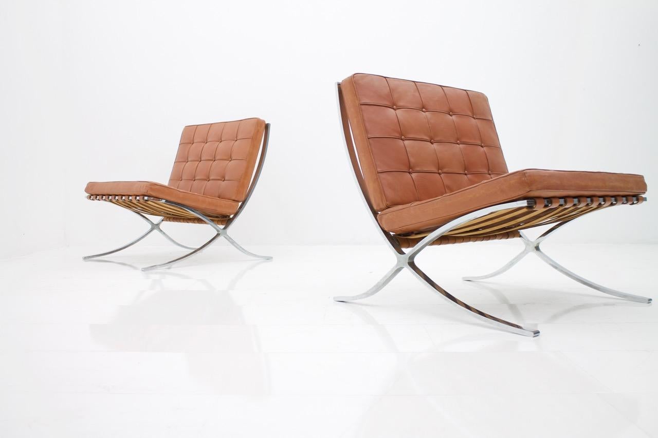 Very rare set of two Barcelona chairs by Mies van der Rohe from the first Knoll Int. production 1955 - 1958. Very good vintage condition. Original leather cushions with a great patina. The foam inside the cushions is soft.

Fantastic