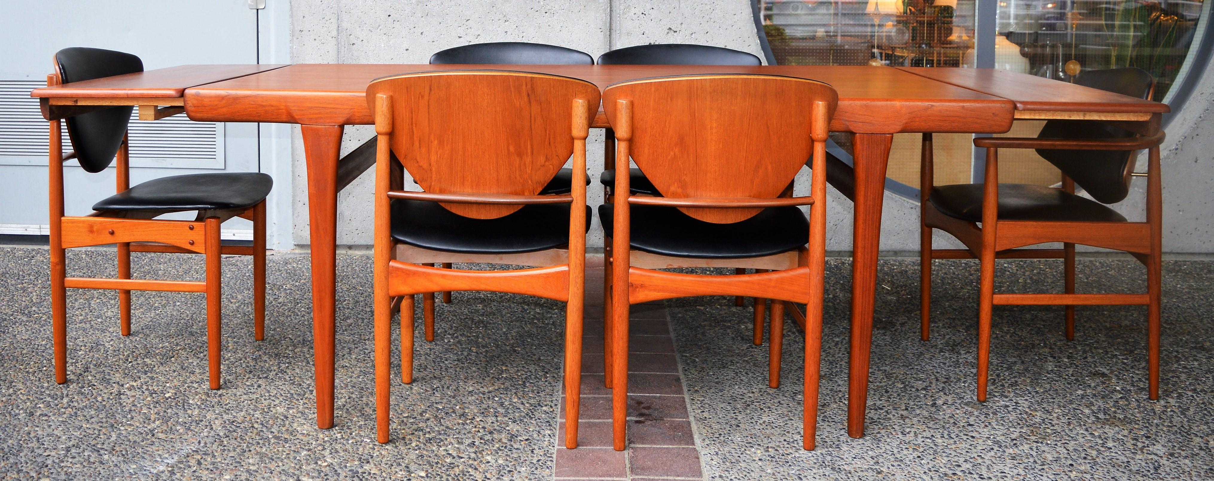 These are incredibly rare and stunning teak dining chairs by Arne Hovmand Olsen in the 1950s with five side chairs and one curved armchair / head chair / carver. Sultry sculptural details throughout, with a teak frame with afromesia teak braces on