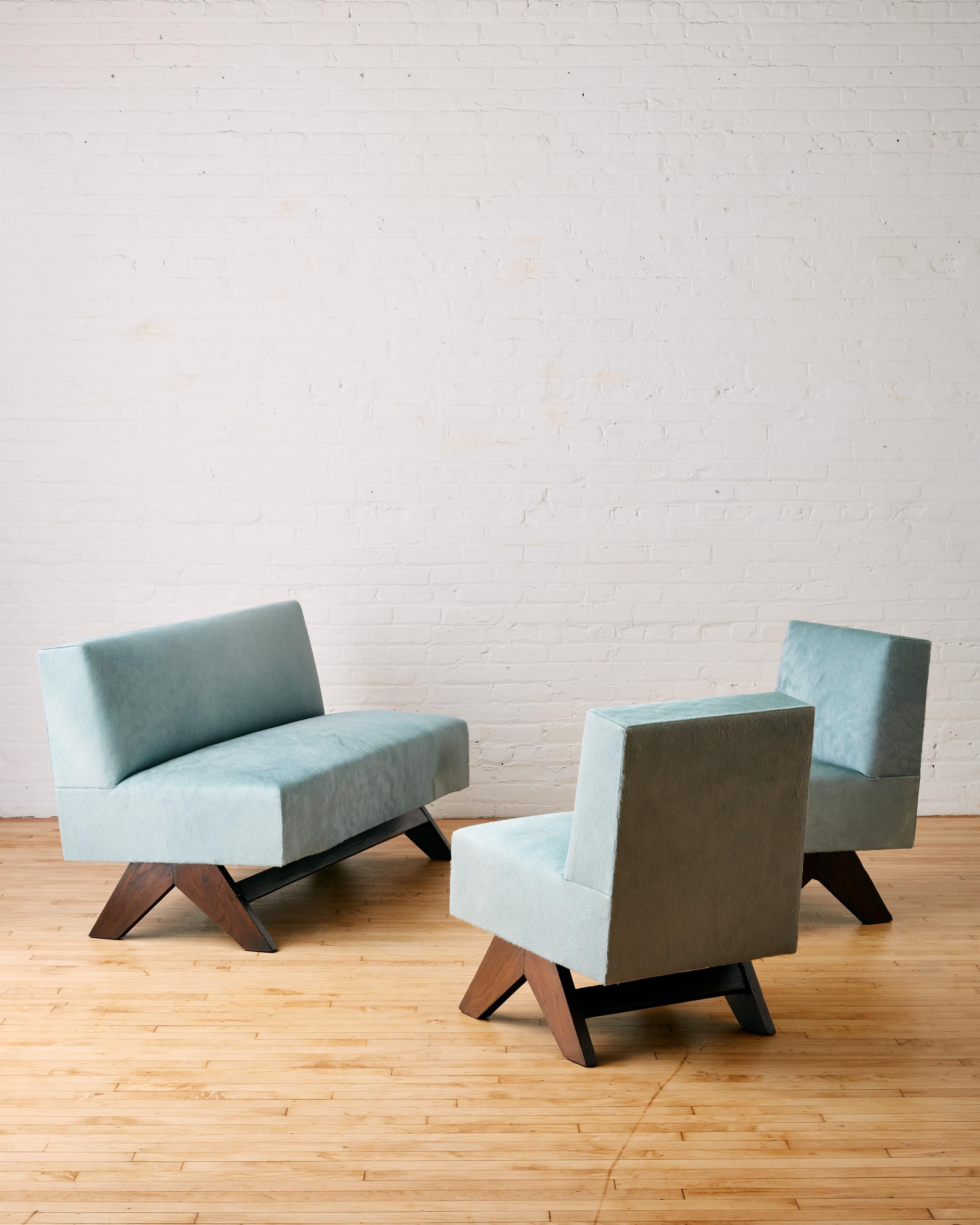 Rare Settee and Pair of Low Lounge Chairs by Pierre Jeanneret with inverted compass type teak legs upholstered in Italian sheared cow hide

The Sette and Lounge chairs have been expertly conserved by MS, New York. Seat interior has been refurbished,