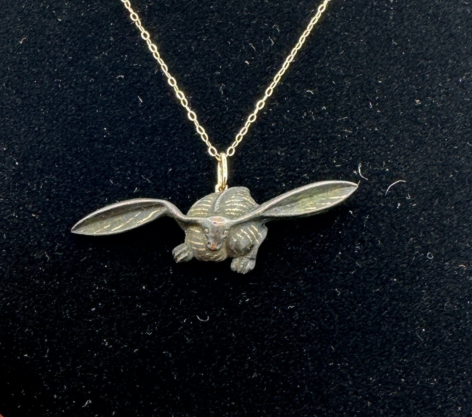 This is a very rare Japanese Shakudo Pendant Necklace in the form of a Bunny Rabbit.  The pendant is a stunning example of the Shakudo art form with the grace and proportion of the image and the Japanese aesthetic of asymmetry.  The crouching rabbit