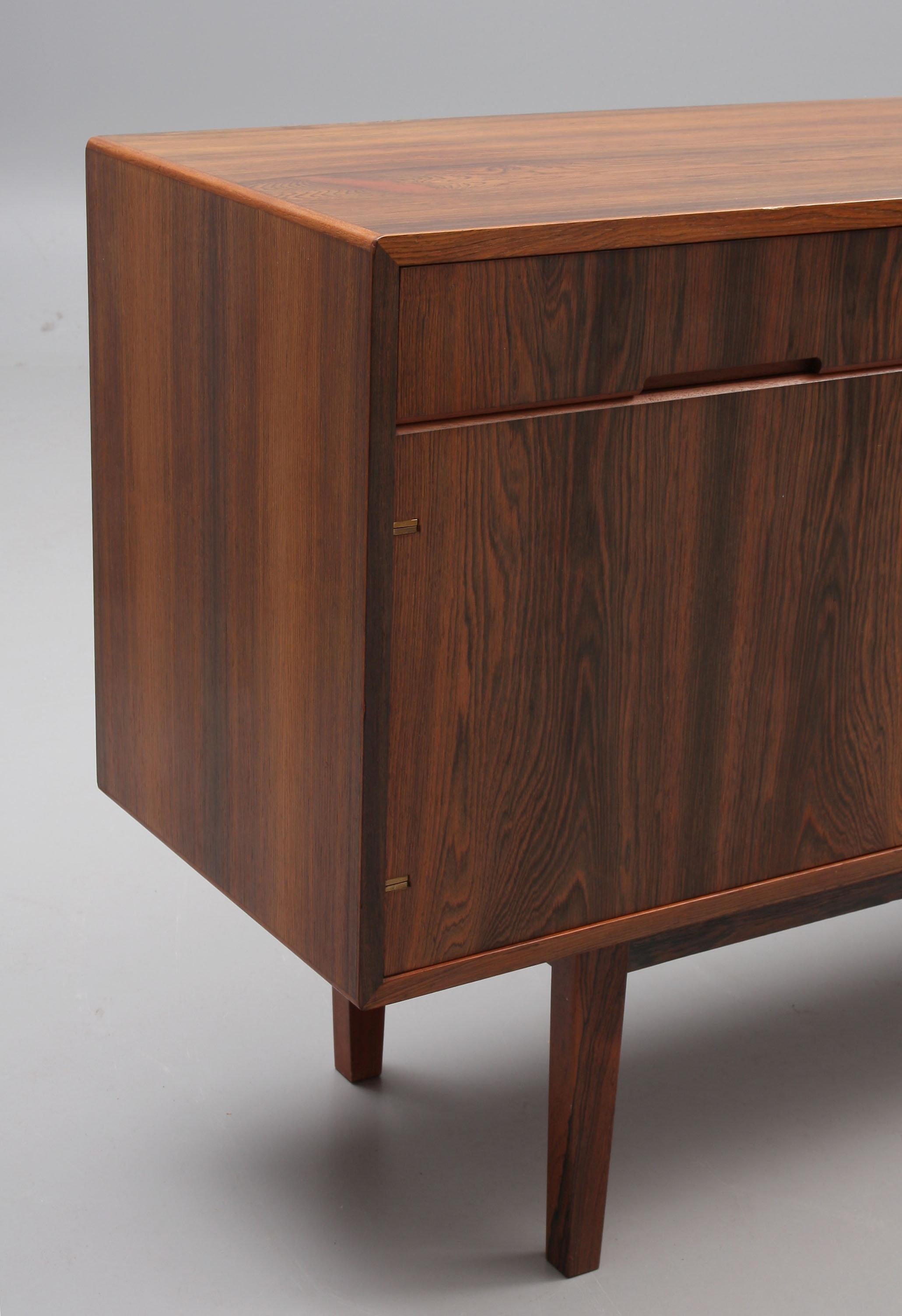 Rare sideboard Rosewood in the style of Ib Kofod-Larsen for Mobelfabrik, 1960
the sideboard features four doors that are tightly fitted side by side, creating a magnificent flat rosewood wall on the front. Only the best veneer parts have been used
