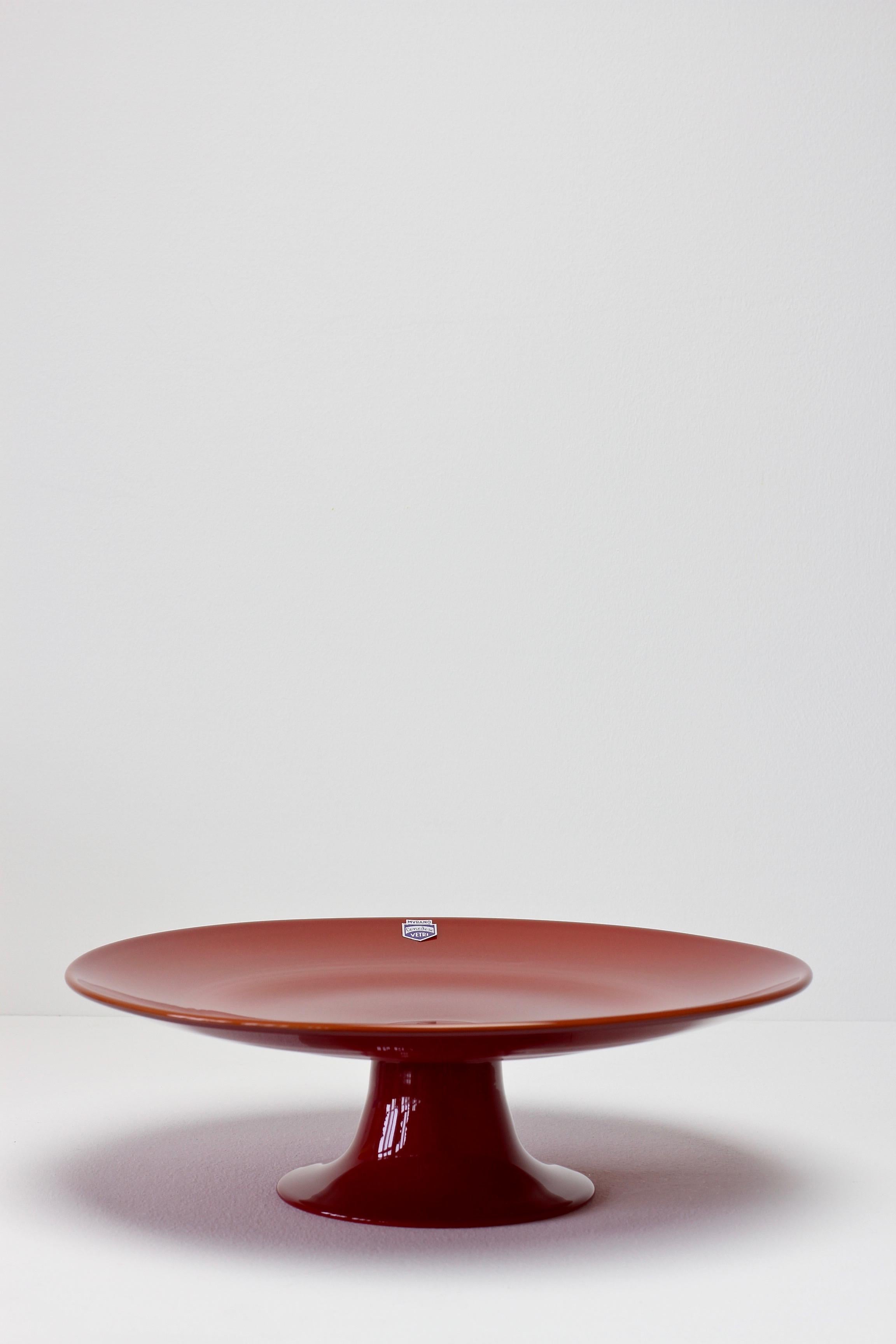 Rare signed Murano glass cake stand or serving plate by Cenedese circa 1970-1990. The design is likely to be by either Antonio da Ros or Ermanno Nason. Wonderful color/colour of dark red and simplistic yet elegant form. Fun to dine with vibrant