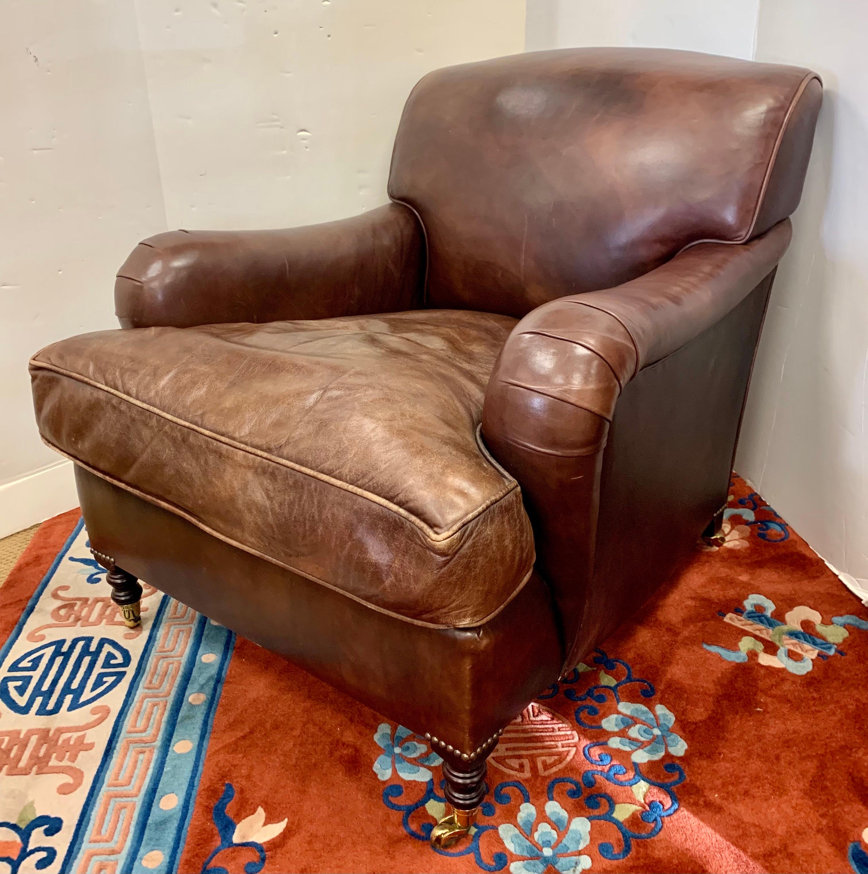 brown leather club chair and ottoman
