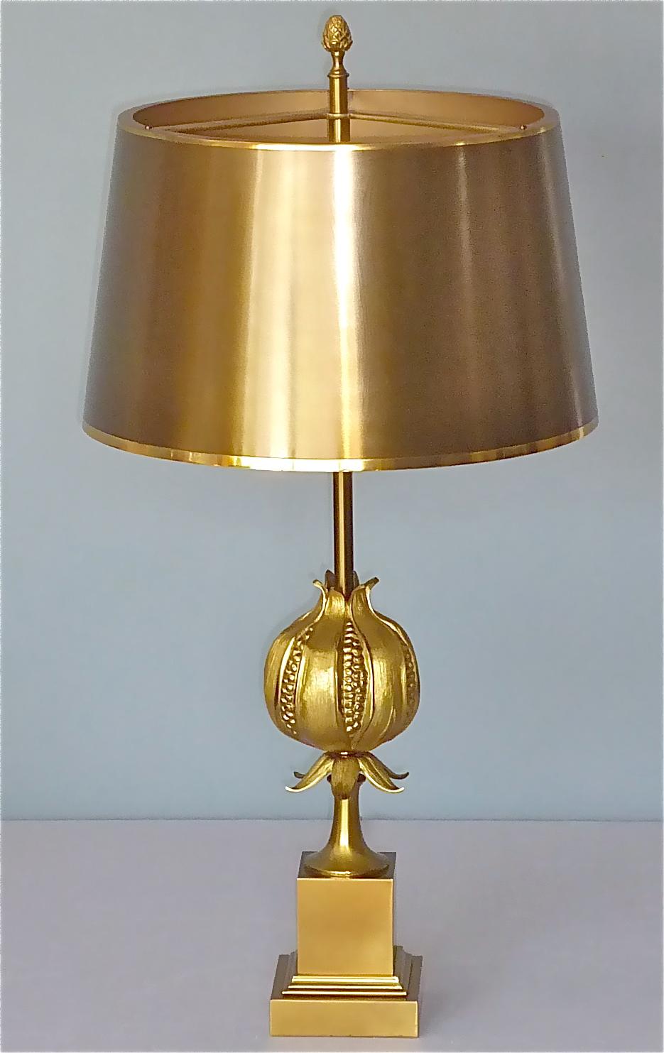 A gorgeous handcrafted heavy and highest quality table lamp by the renowned and famous french company Maison Charles, Paris, France, circa 1970s. Made of gilt and solid hand-cast and carved bronze with a seamless spun brass shade with finial