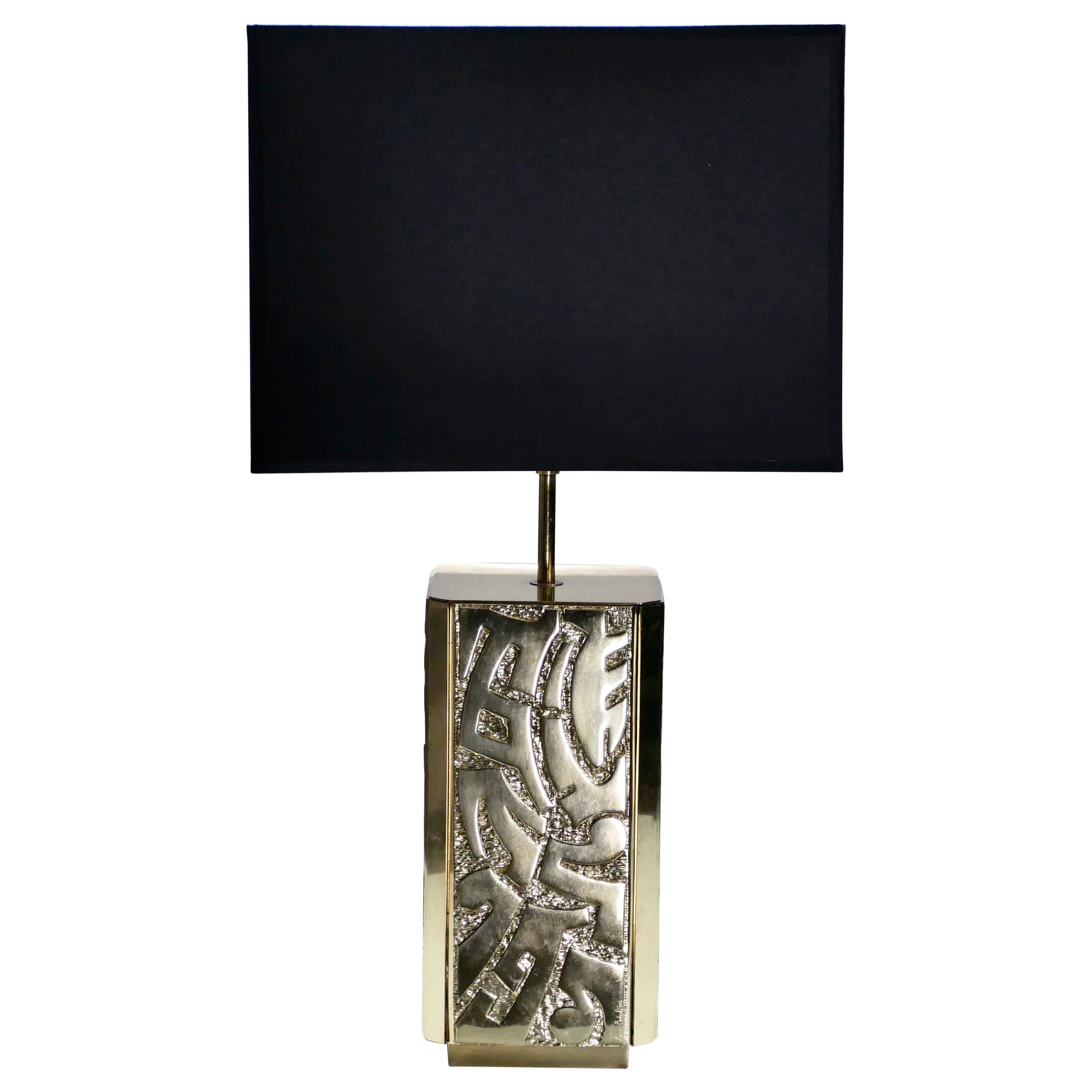 This large vintage table lamp is signed by Lova Creation. The sculptural quality of the piece is visually arresting, bronze shaped delicately into abstract forms all along the base. Silky texture of the foreground contrasts the ridged texture of the