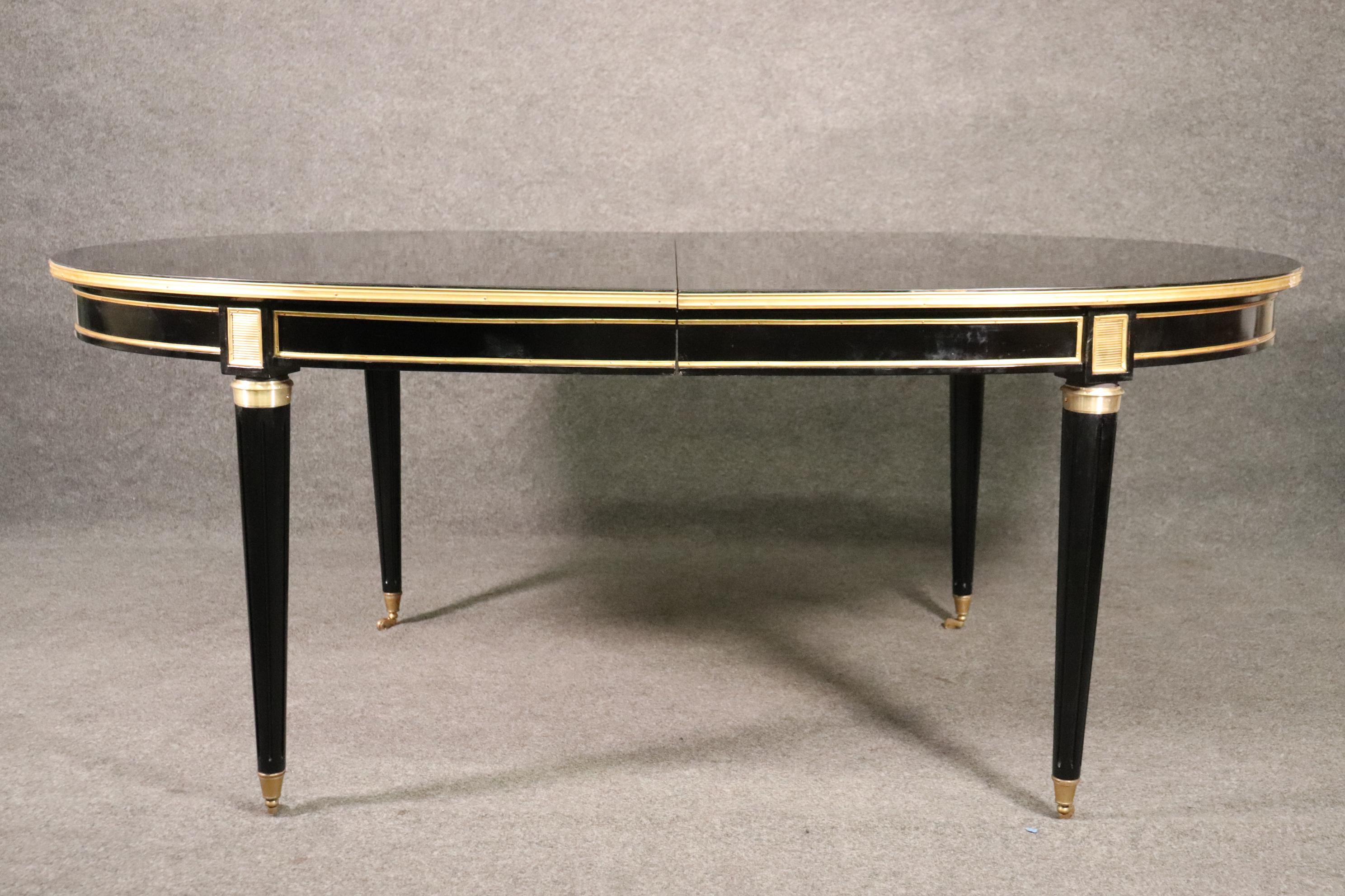 This is a truly wonderful table made of mahogany with brass or bronze mounts and while it does look streaky, it just needs polishing to make it look its best which we will do for you. The table top and leaves are actually in very good condition and