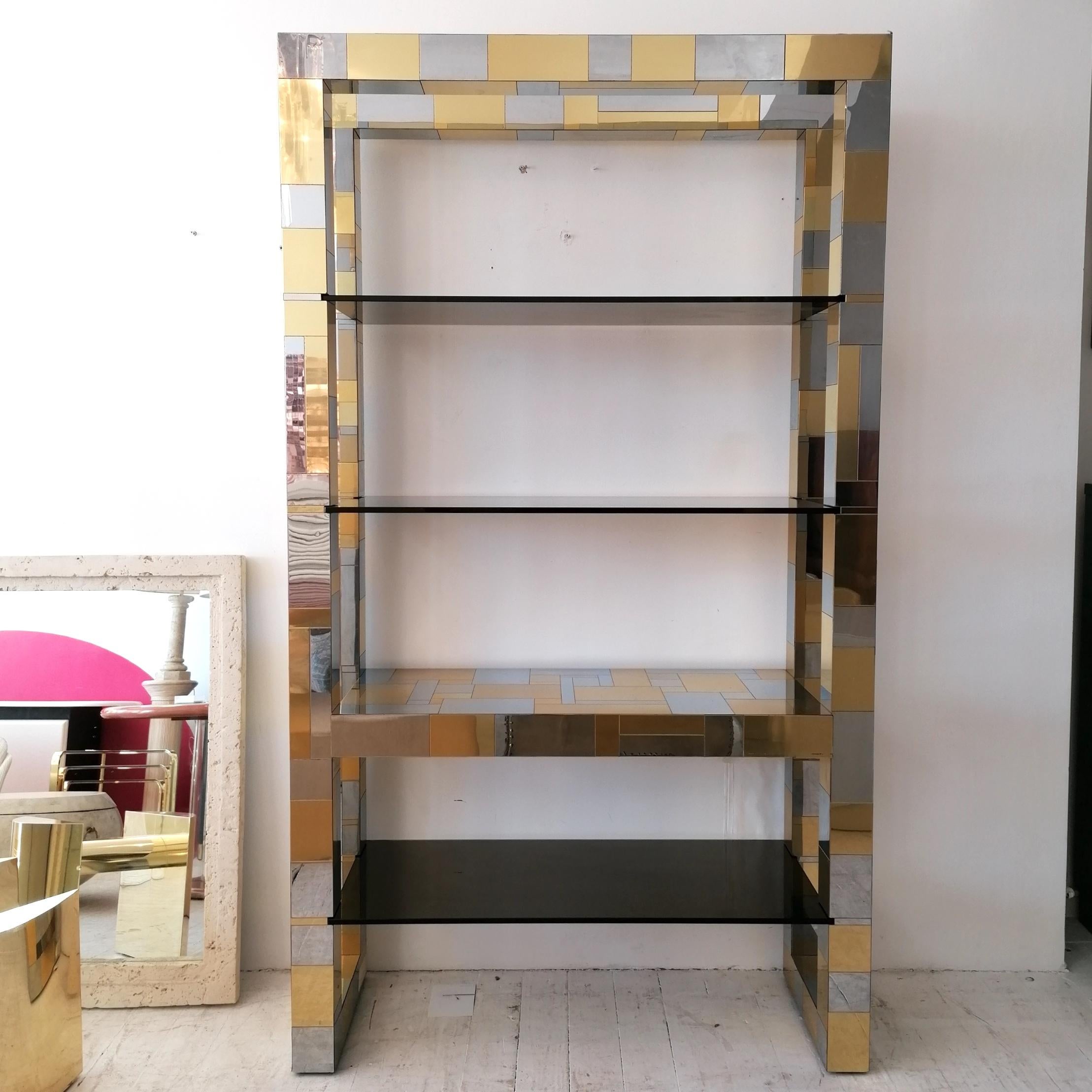 A rare signed iconic Paul Evans 'Cityscape' large freestanding etagere, USA 1970s. Chrome & brass clad patchwork design- even on the underside- with thick smoked glass slot-in shelves.
Light age-related wear...light scratches and scuffs. One shelf