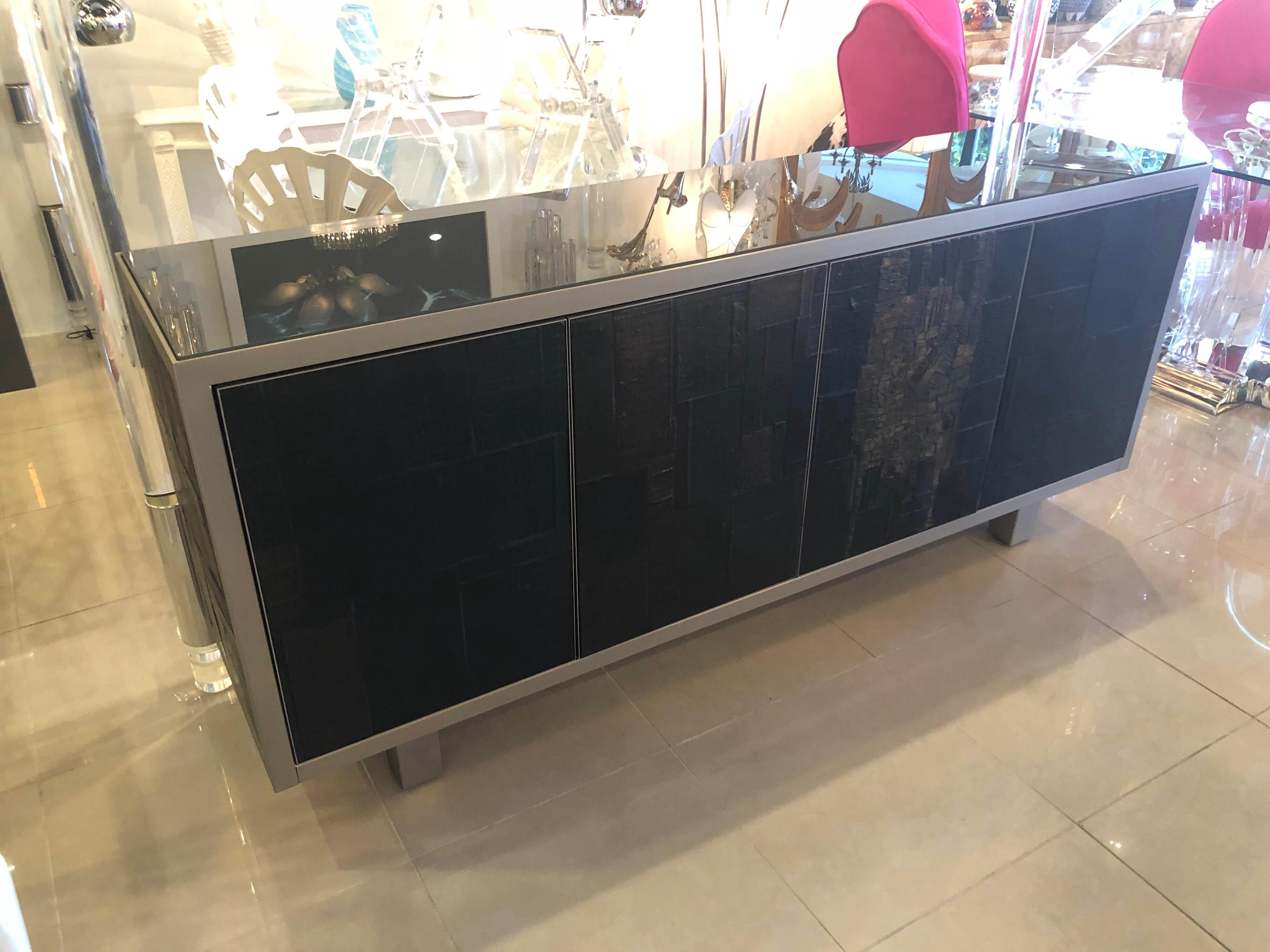 Rare signed Pia Manu (pictures) Ceramic slate sculpted 4-door Credenza Buffet Sideboard. One side has a lined drawer (pictured) and the other side has the original glass shelf (pictured). There are some minor scuffs to the side metal (shown in two