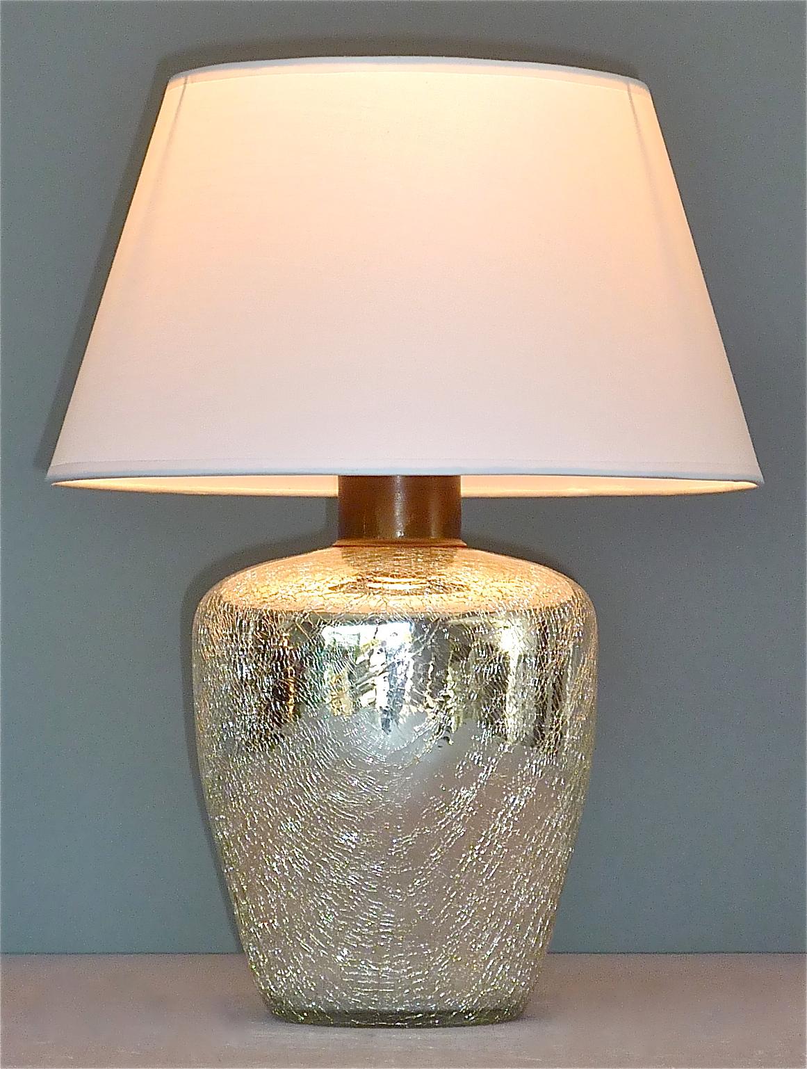 Rare Modernism Art Deco table lamp in thick silver mirrored glass with crackle effect finish which can be dated France circa 1930s. It has a patinated metal fixture with a black plastic fitting for one E 27 screw bulb to illuminate, we recommend LED