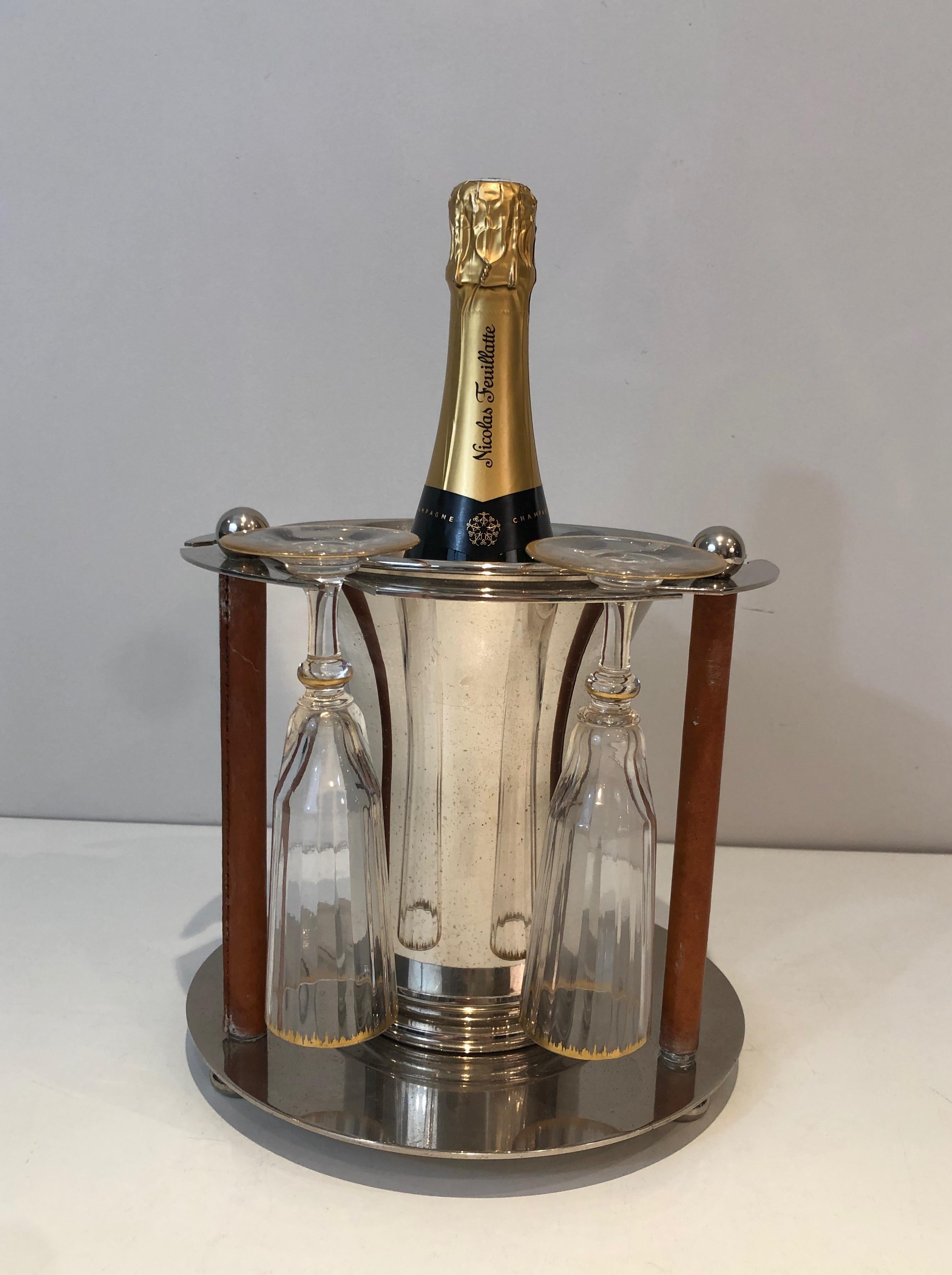 This rare champagne bucket with flutes holder is made of silver plated and leather. This is a French work. Circa 1970. A pair is available.