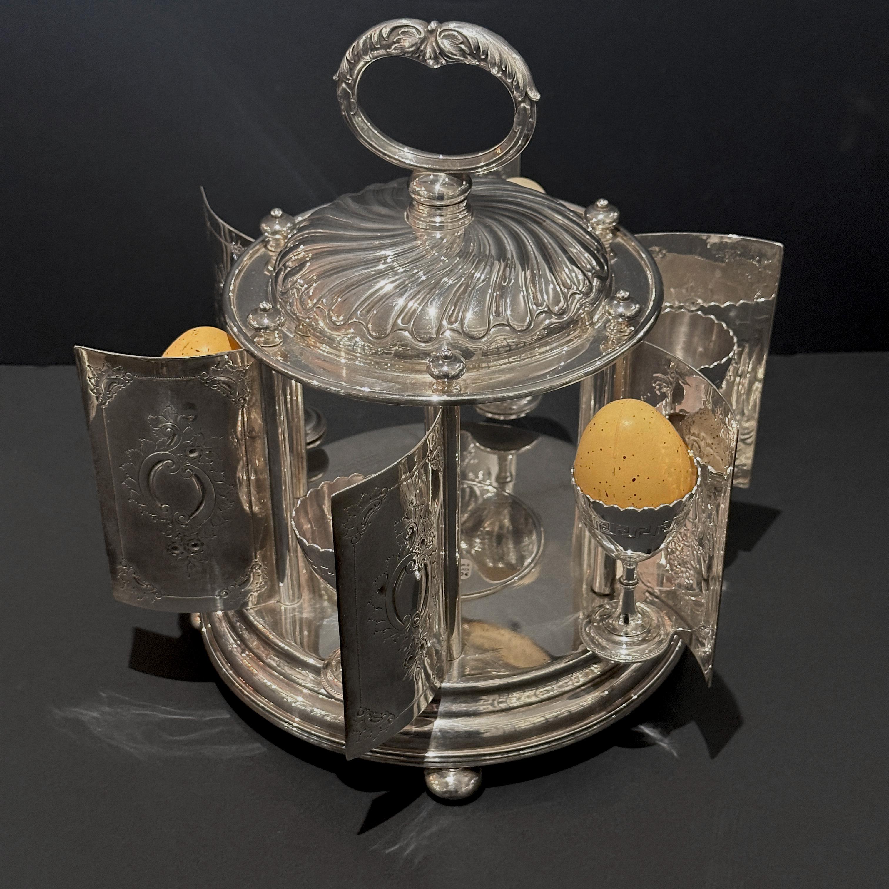 Rare Mappin & Webb Egg Carousel with Six Rotating Panels

This exquisite egg carousel, crafted in London by Mappin & Webb, is designed to keep your morning soft-boiled eggs warm. It's a charming and delightful presentation piece featuring six egg