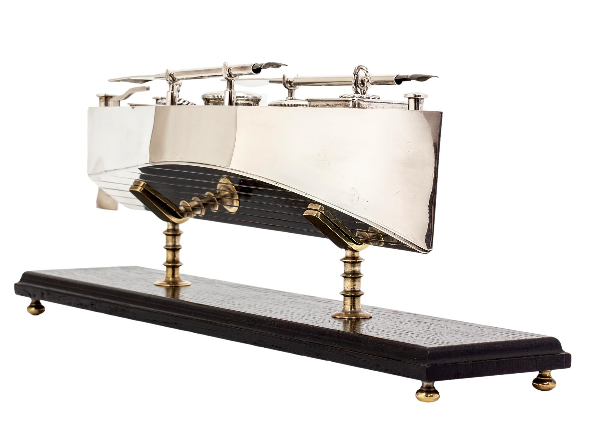 Late 19th Century Circa 1880

From our Silver collection, we are delighted to introduce this superb Silver Plated Novelty Boat Inkstand Desk Set. The Desk Set of novelty form modelled as a classic sailing rowboat with realistic hinged rear rudder,