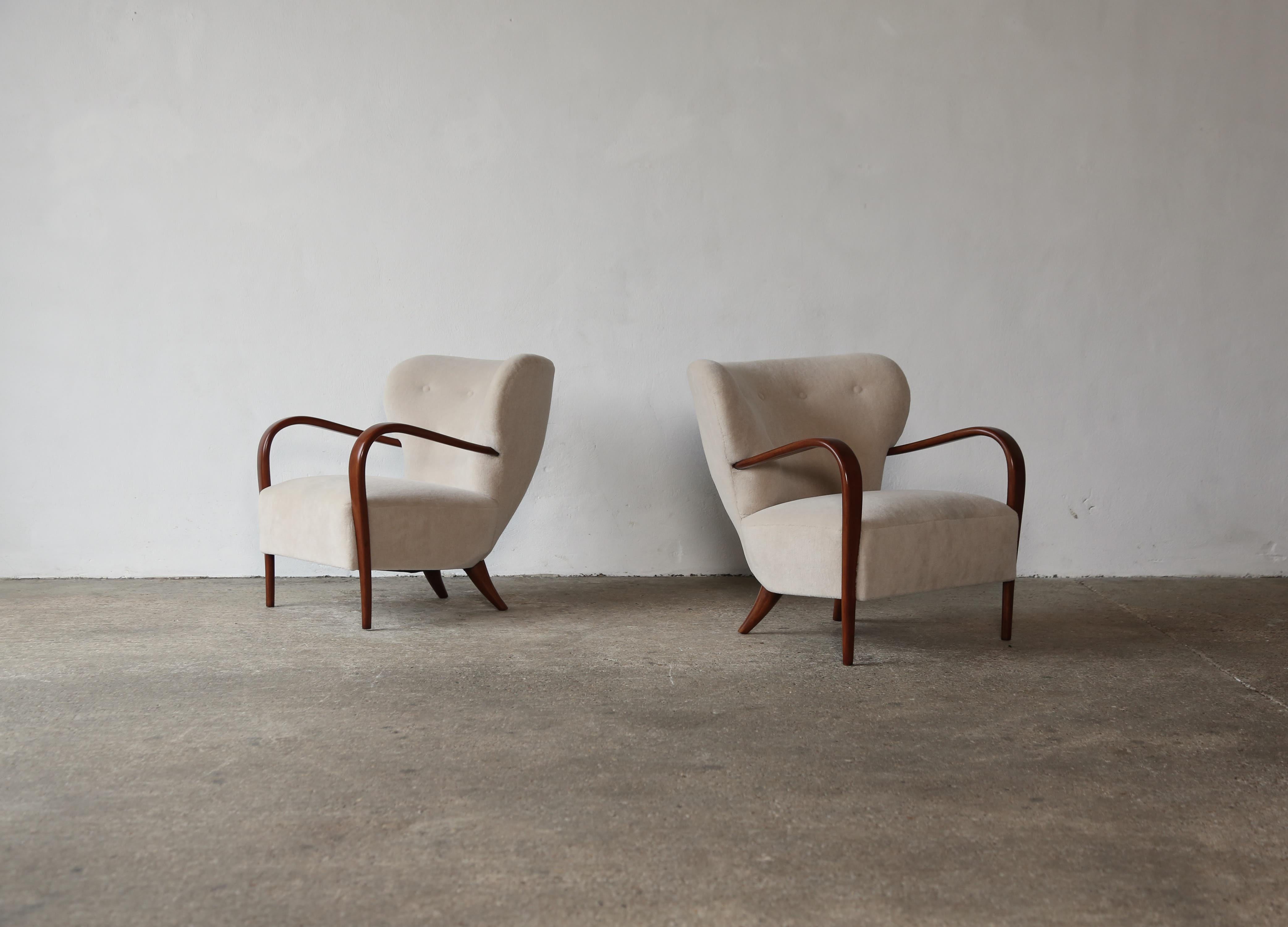 A rare and important pair of 1940s armchairs designed by Silvio Cavatorta. Made by hand in the Cavatorta workplace in Rome.   In very good restored condition these chairs are newly upholstered in a bespoke, premium, soft, pure alpaca wool fabric. 
