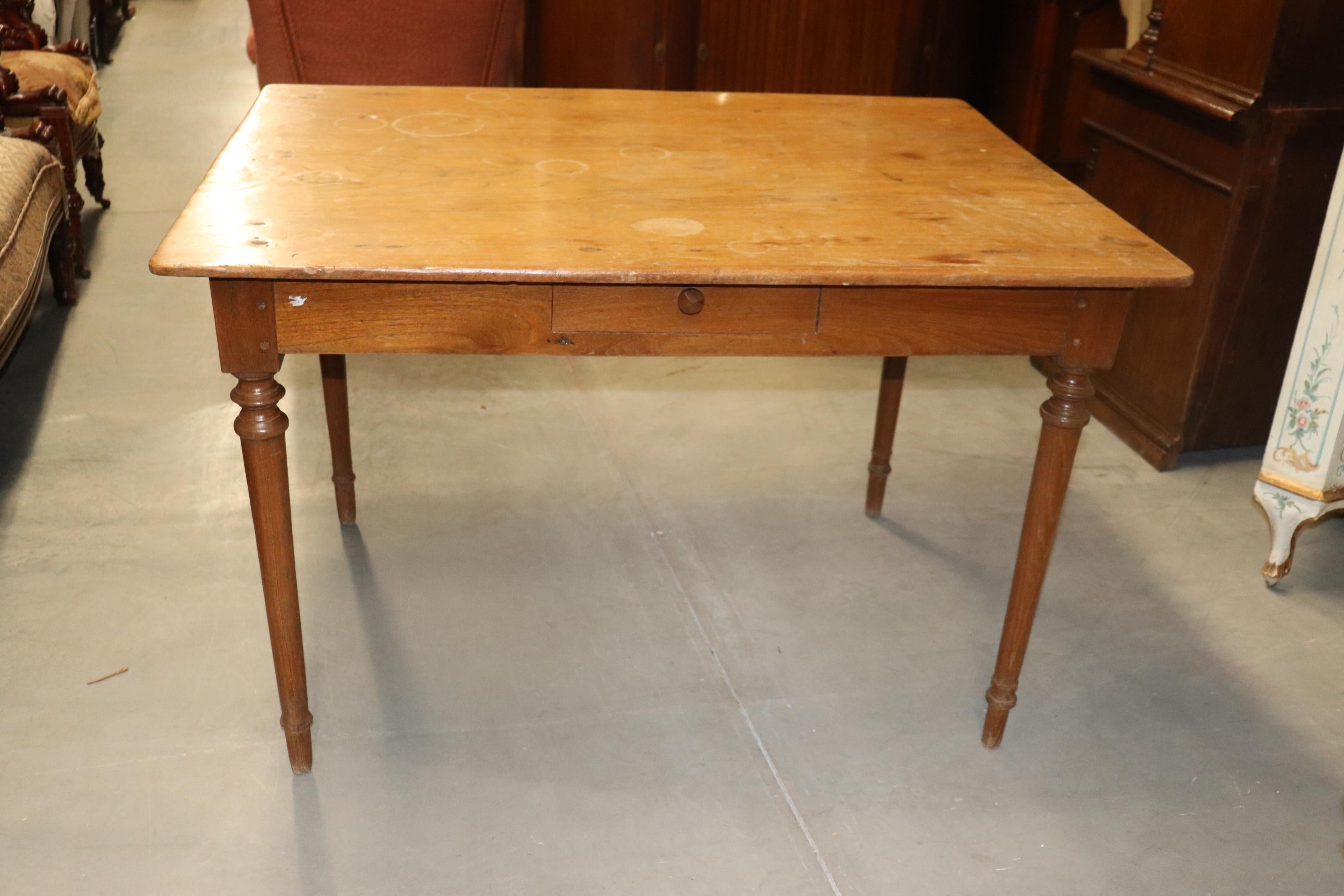 This is a fantastic and ultra rare French country farm table with SINGLE BOARD of either walnut or perhaps chestnut. The top is 45 inches wide so that was a mighty large tree! The table is in its original condition and does have old rings from