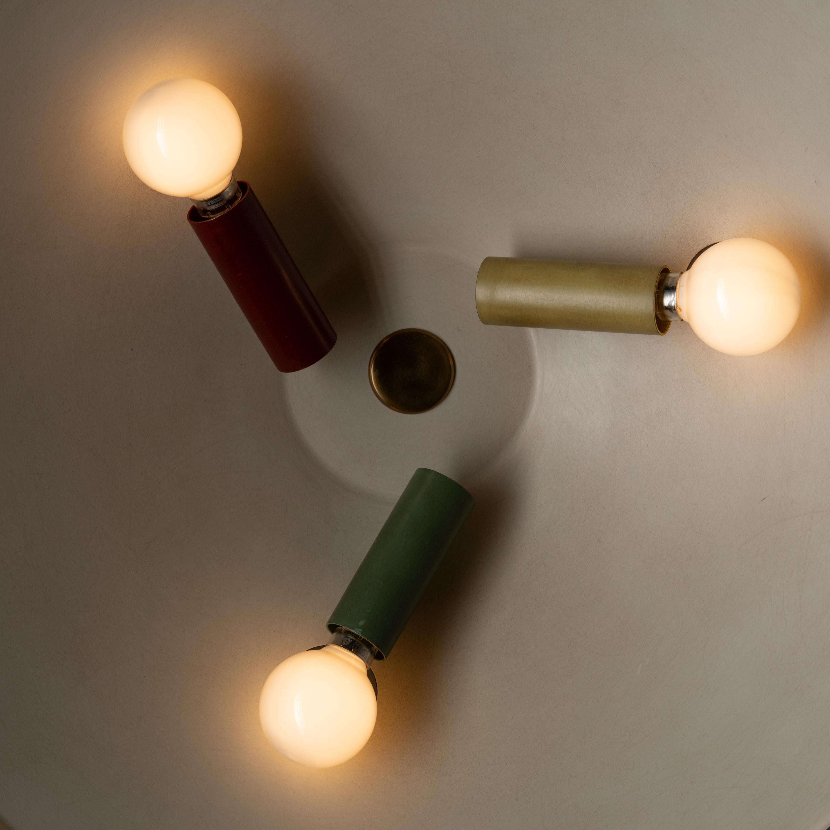 Rare flush mount ceiling lights by Stilnovo. Manufactured in Italy, circa 1950s. Enameled aluminum with a trio of red, yellow, and green socket covers. Hardware in brass. Rewired for U.S standards. Holds three E14 sockets, adapted for the US.