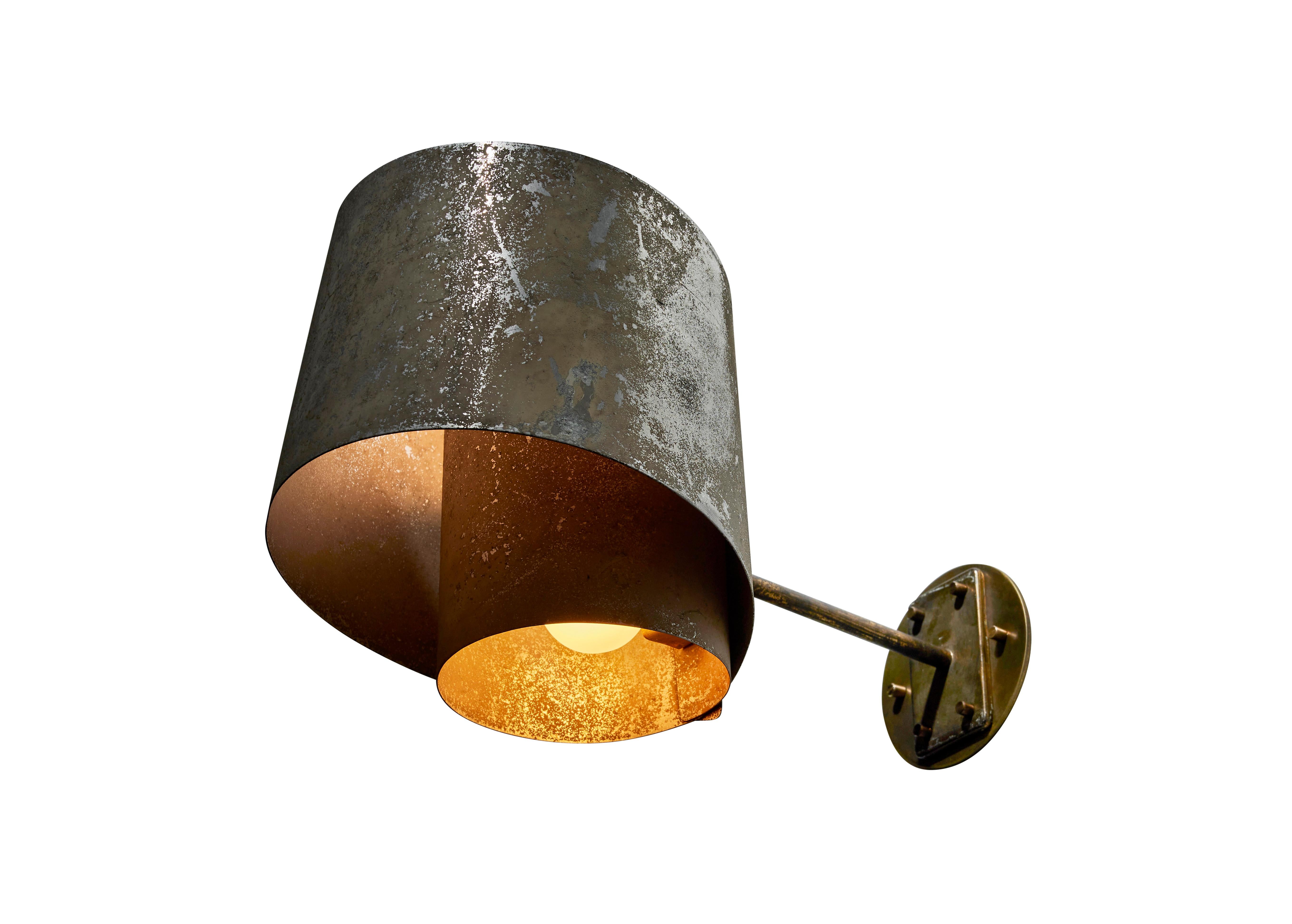 Rare single sconce by Giussepe Ostuni for Oluce. Designed and manufactured in Italy, circa 1950s. Brass, enameled aluminum. Custom brass backplate. Rewired for U.S. standards. We recommend two E14 40w maximum bulbs. Bulbs provided as a one time