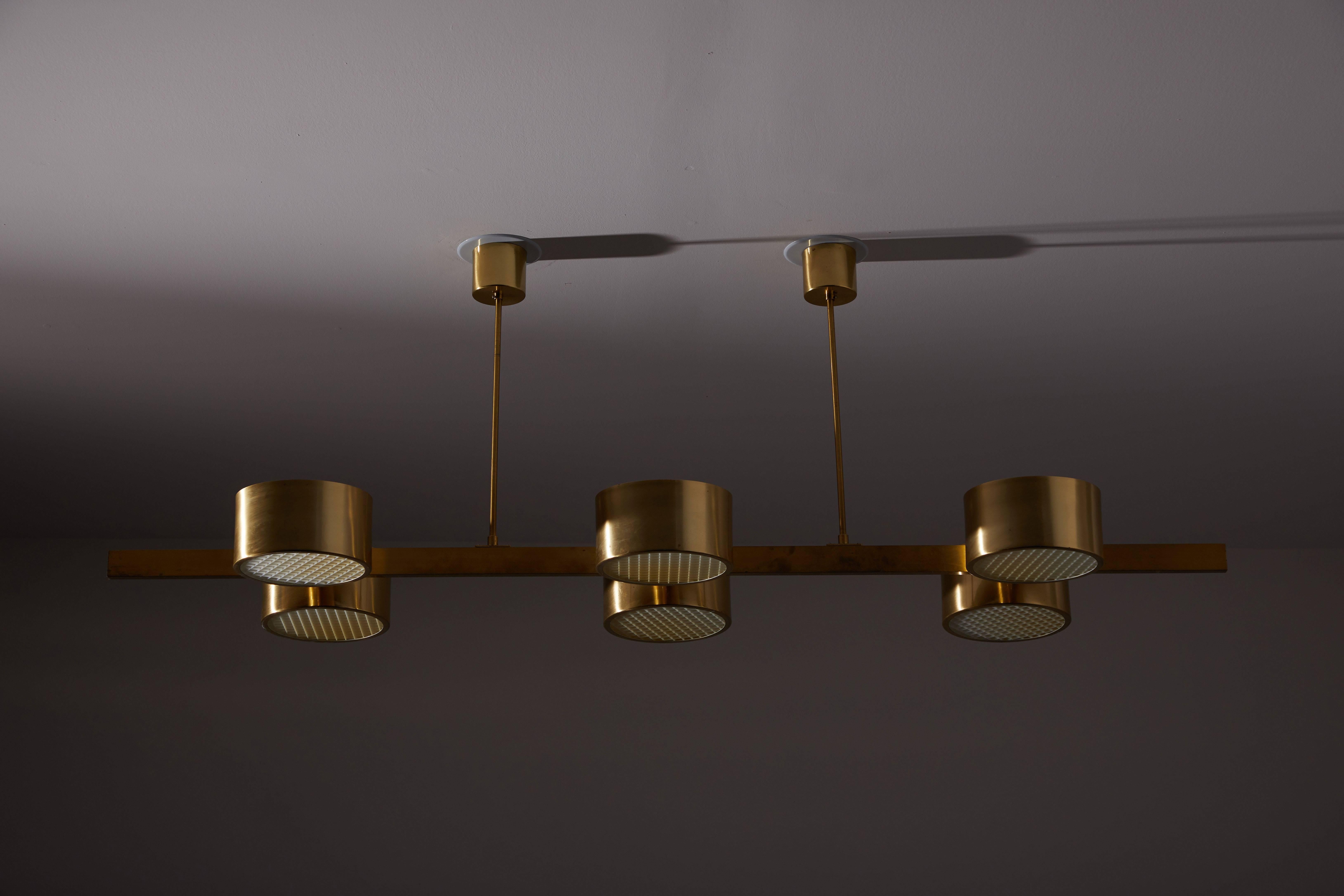 Rare six-shade chandelier by Hans-Agne Jakobsson. Designed and manufactured in Sweden, circa 1970s. Rewired for US junction boxes. Custom ceiling plates. Brass, with glass diffusers and acrylic grid covers on diffusers. Takes Six E27 40w maximum