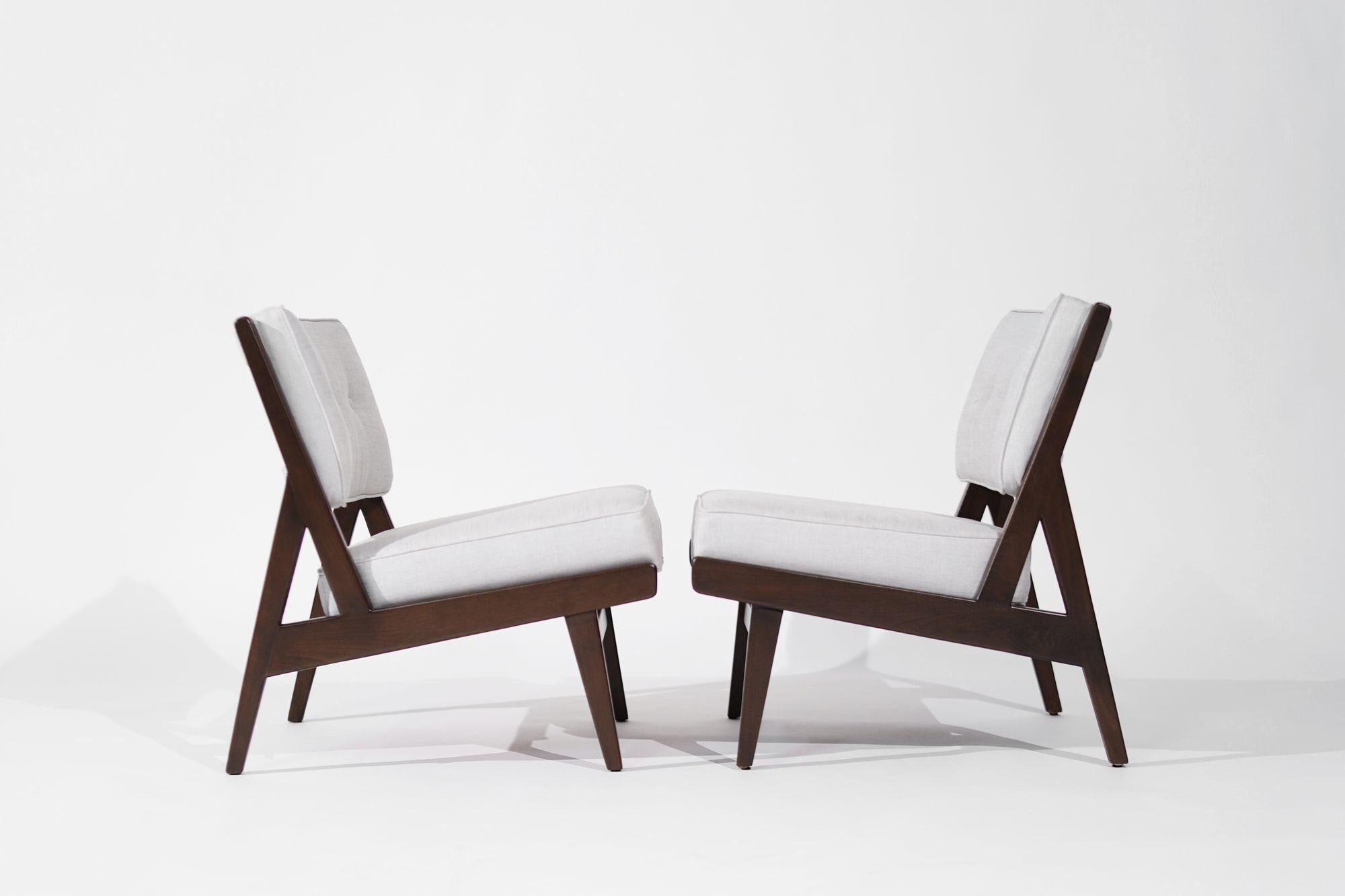 Experience the epitome of mid-century modern elegance with our fully restored walnut slipper chairs from the 1950s, a timeless creation by Jens Risom for Risom, Inc. Meticulously refurbished and reupholstered in luxurious Gray Linen, these chairs