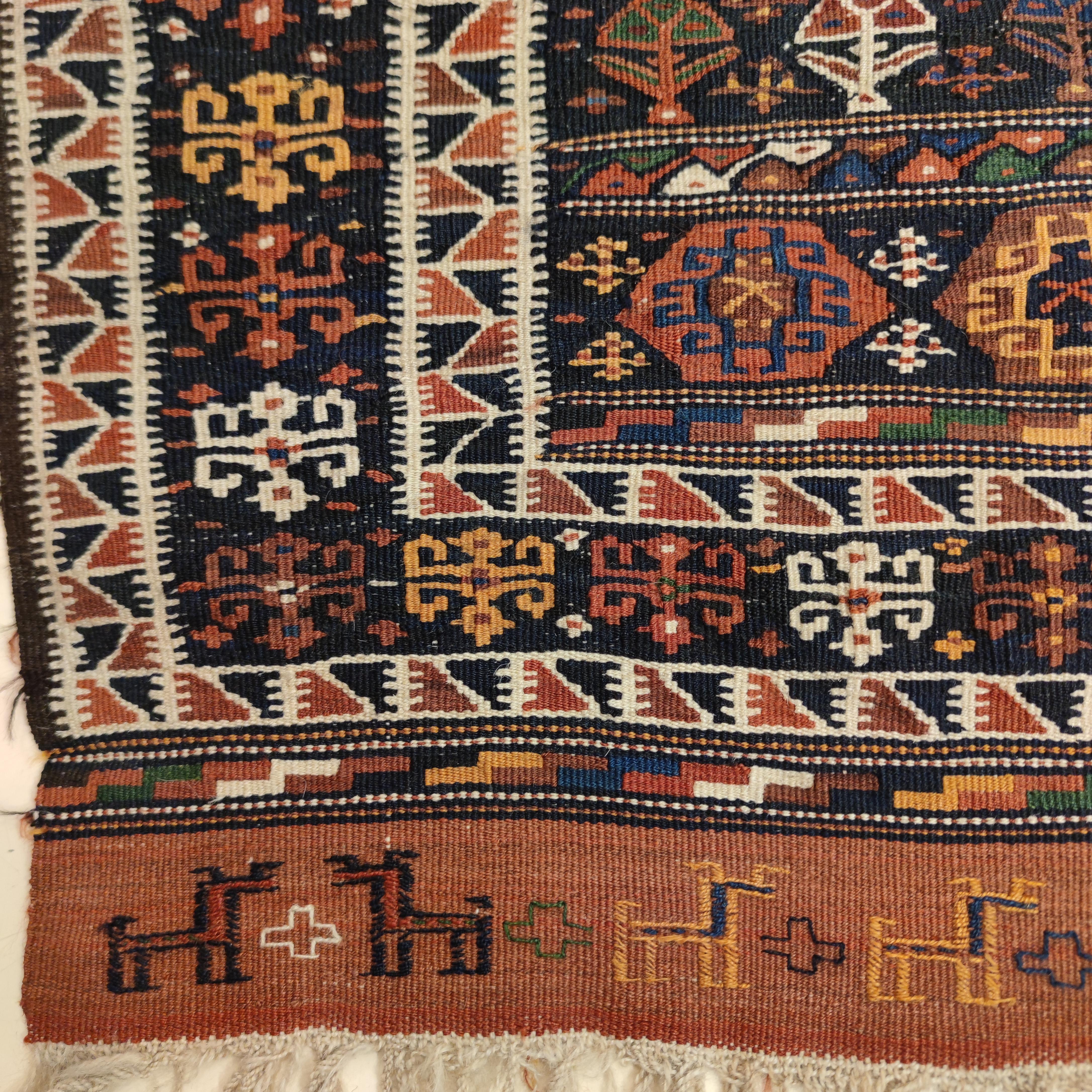 A very rare and beautiful small Caucasian kilim from northern Azerbaijan decorated by horizontal compartments on an indigo blue background. Each compartment is embellished by a plethora of zoomorphic motifs belonging to the historical iconography of