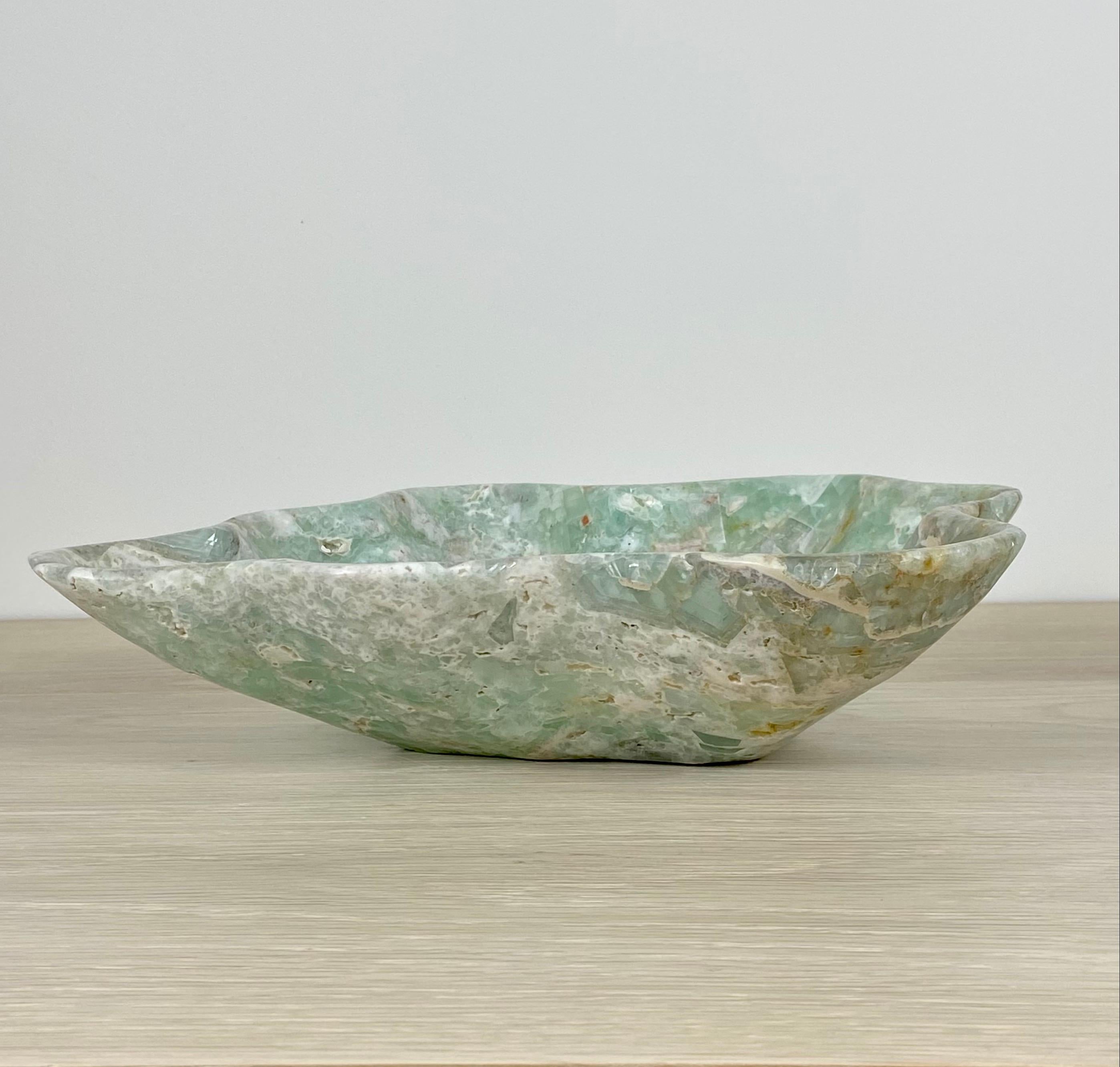 An unusual and very pretty small green onyx bowl with beautiful veining. This one of a kind decorative bowl is meticulously hand-carved from a single piece of onyx by skilled artists to reveal its' inherent characteristics. This stone bowl is a